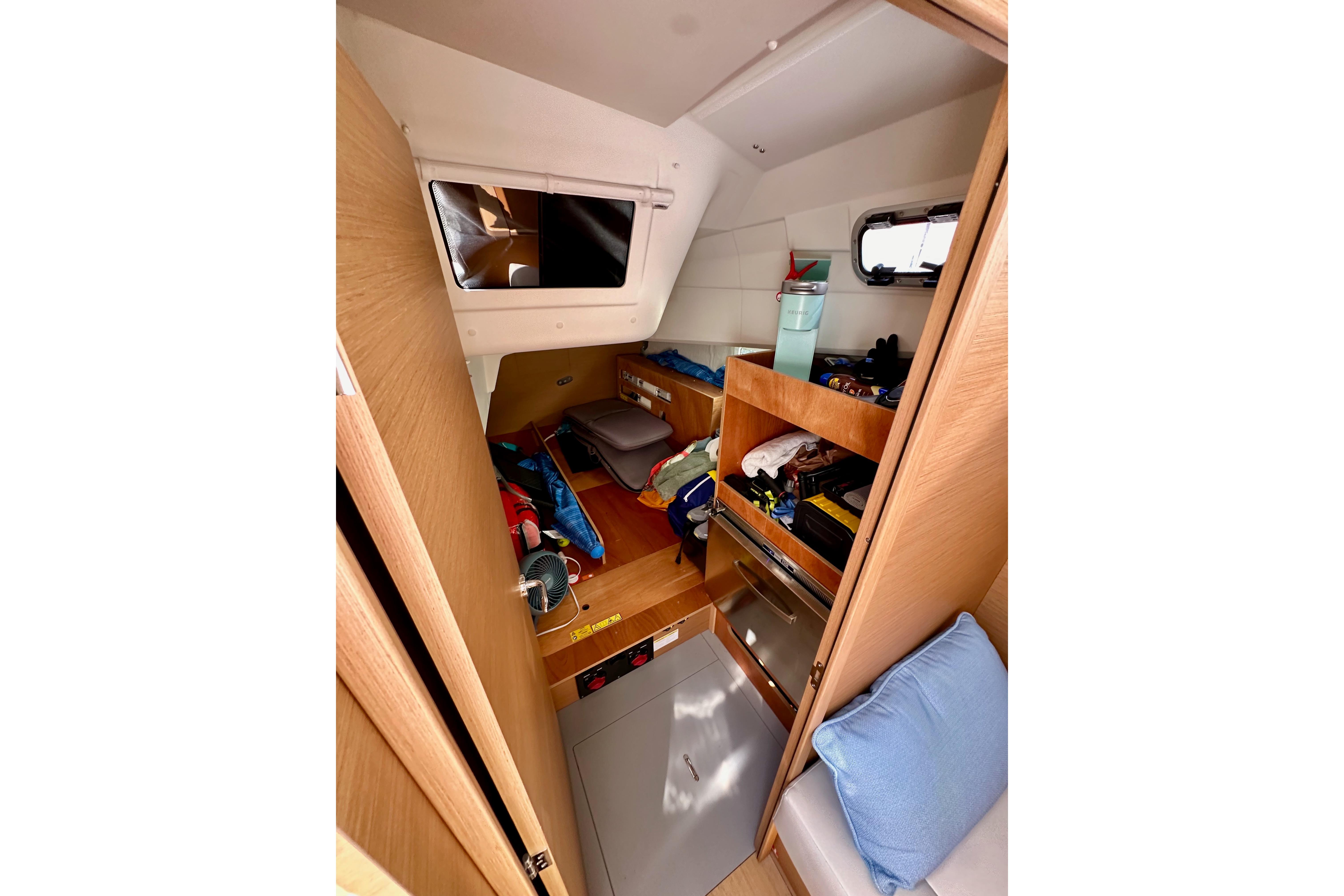 Interior cabin of 2024 Jeanneau Sun Odyssey 410 sailboat, featuring storage and seating.