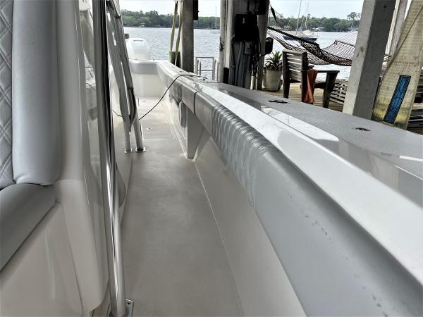 2020 Front Runner 39 Center Console boat docked, showcasing sleek white interior and waterfront view.