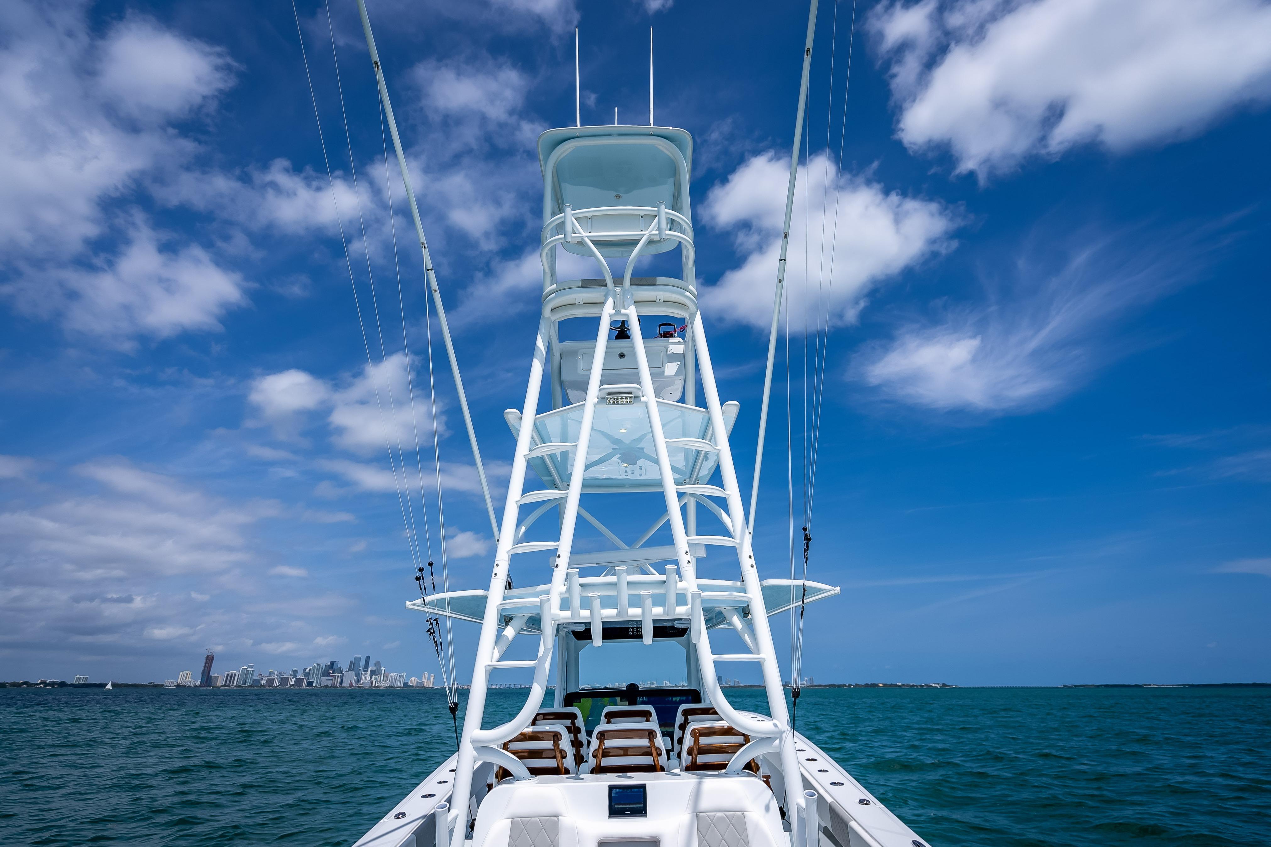 Freeman 43 boat on open water, clear sky, city skyline in background, 2025 model.