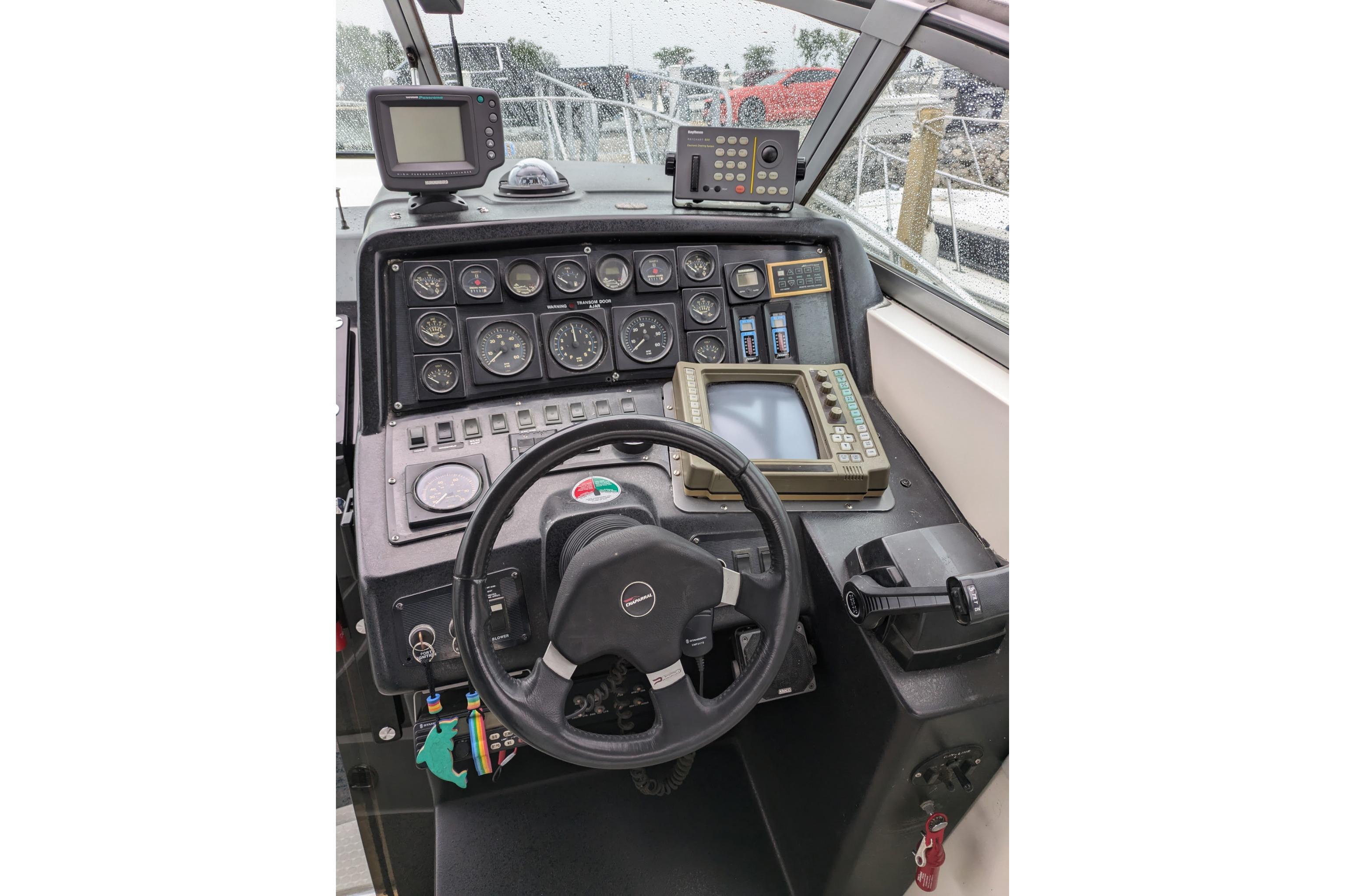 1992 Chaparral Signature 30 boat dashboard with steering wheel and navigation instruments.