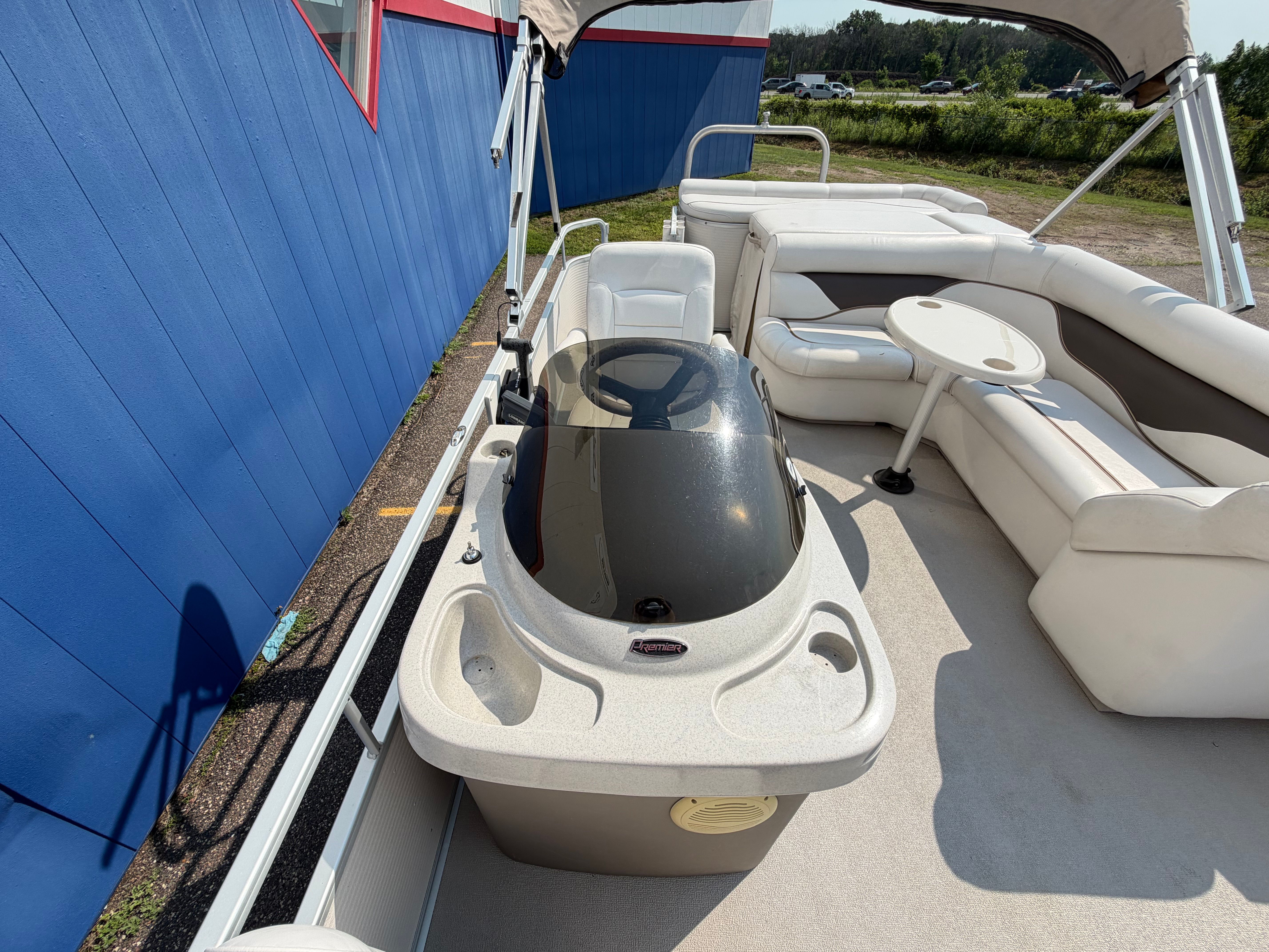 The image shows the deck of a 2007 Premier 225 Sunsation pontoon boat with seating areas.