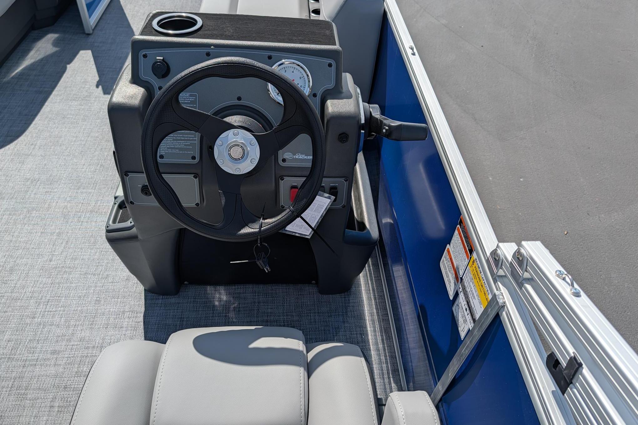 Steering console of 2026 Sun Tracker Party Barge 16 DLX pontoon boat.