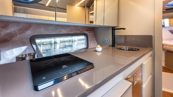 Modern kitchen interior in 2025 Hanover 415 yacht with sleek countertops and appliances.