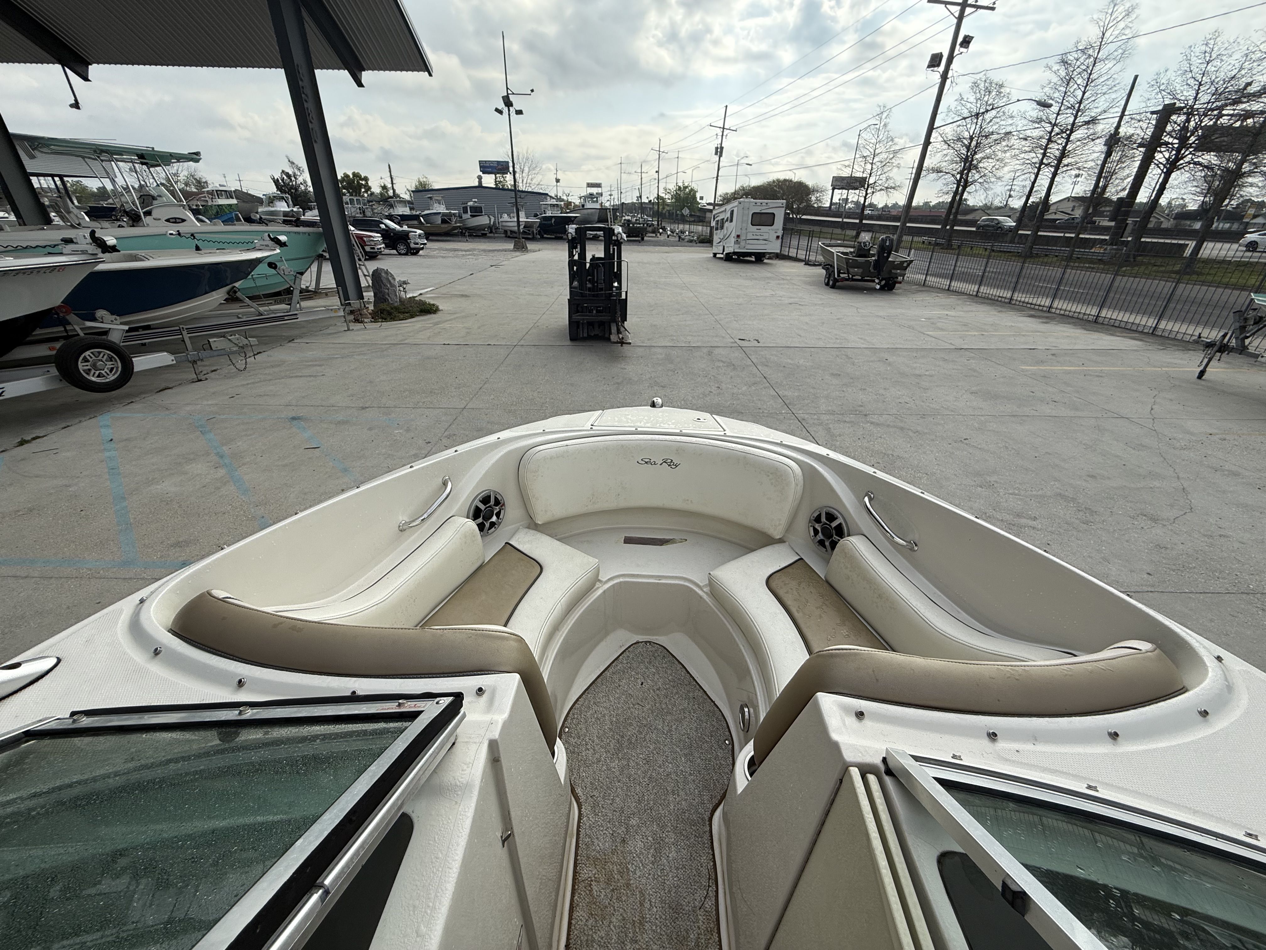 Interior view of a 2007 Sea Ray 210 boat on a parking lot.