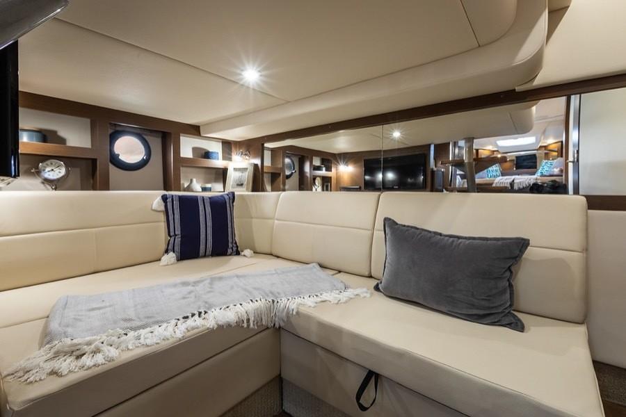Manufacturer Provided Image: Interior of 2021 Sea Ray Sundancer 350 Coupe with beige seating and decorative pillows.