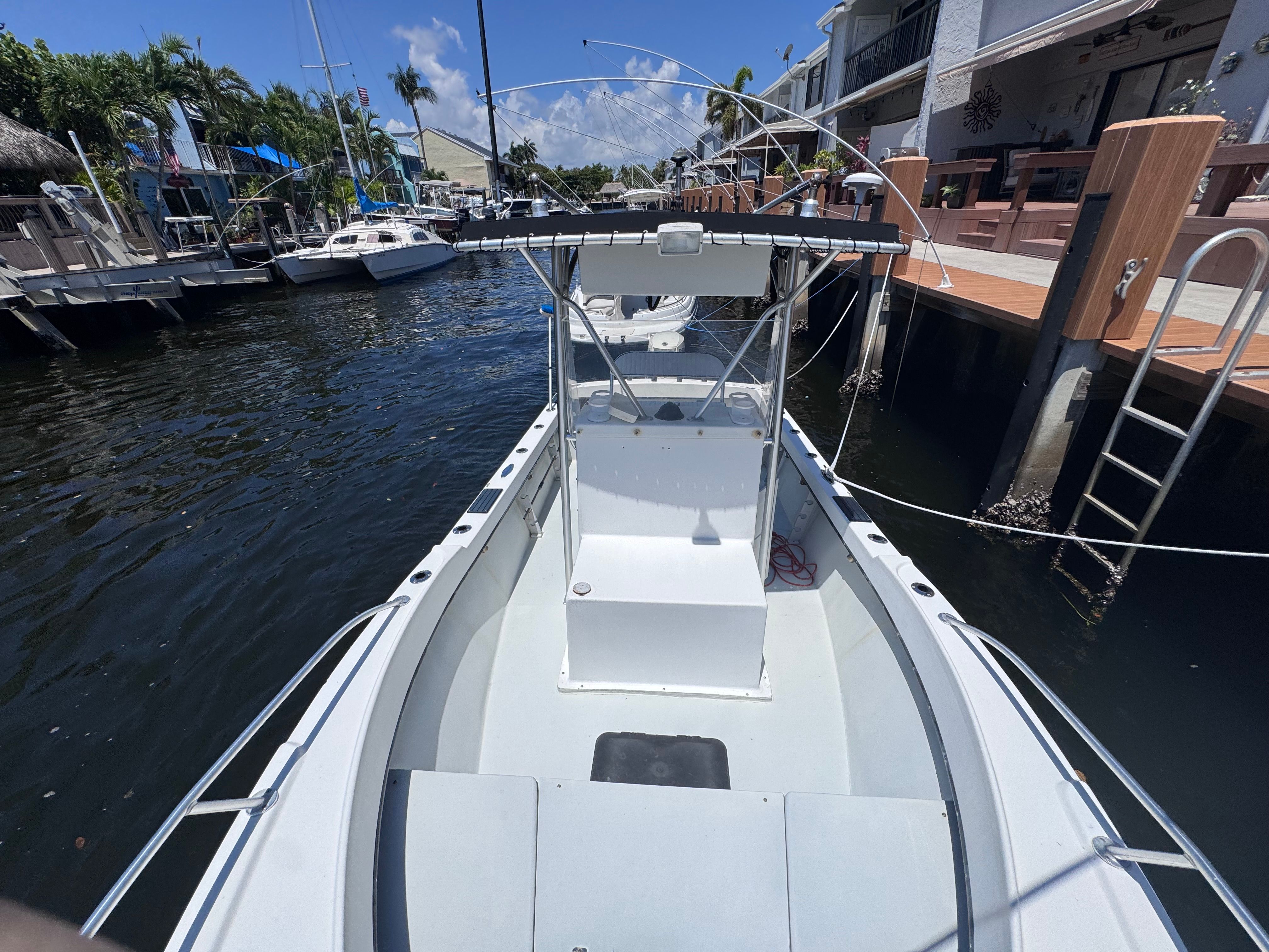 1998 Dusky 20.3 boat docked in marina, sunny day.
