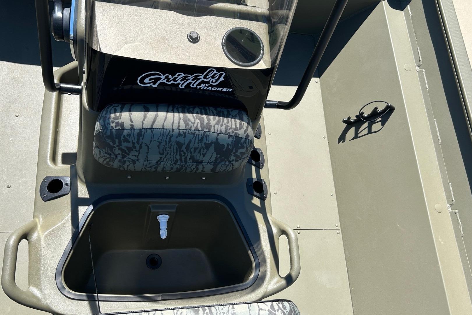 2026 Tracker Grizzly 2072 CC boat interior with camo seat and steering console.