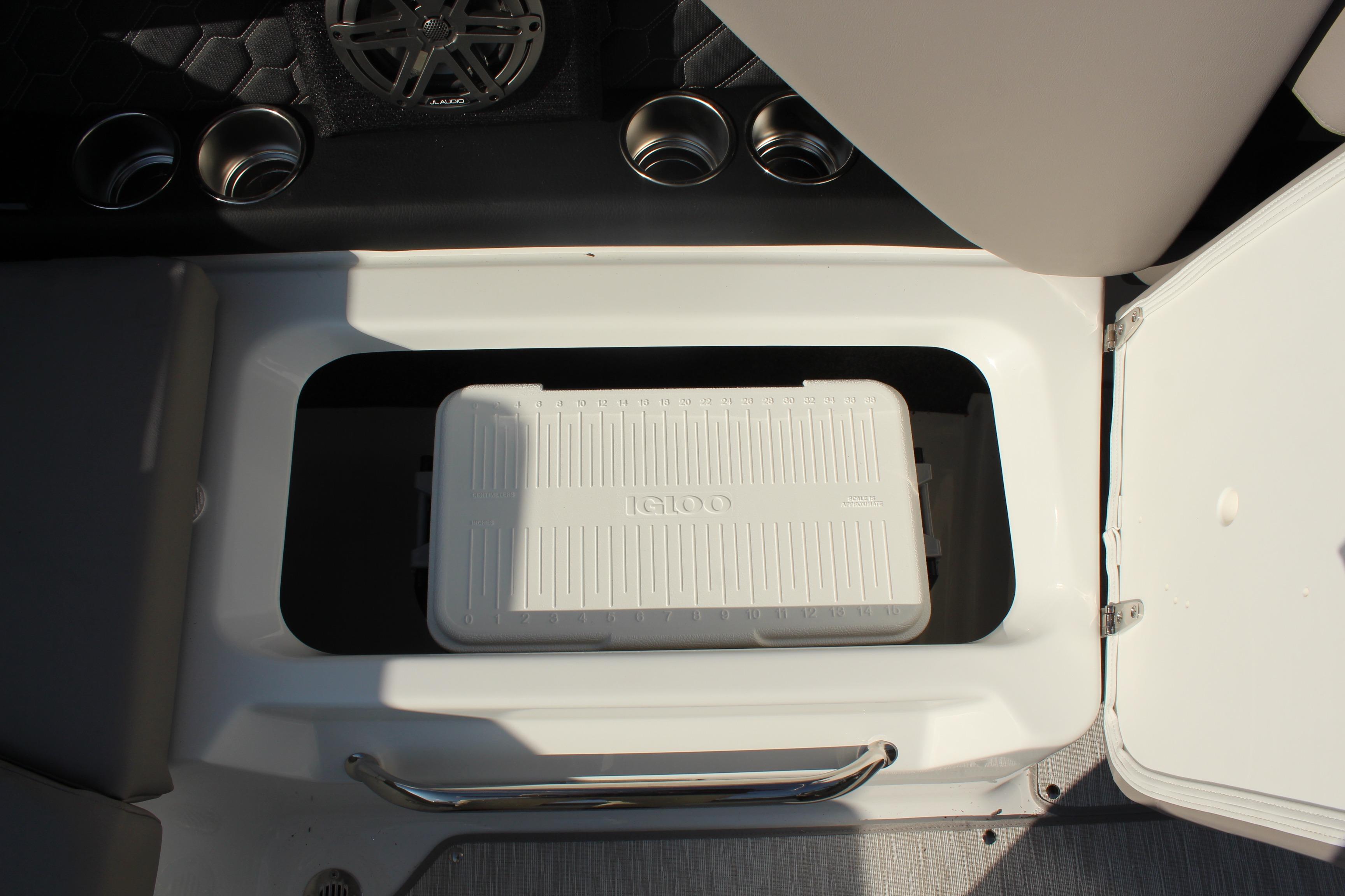 2026 Four Winns H4 boat storage compartment with Igloo cooler and cup holders.