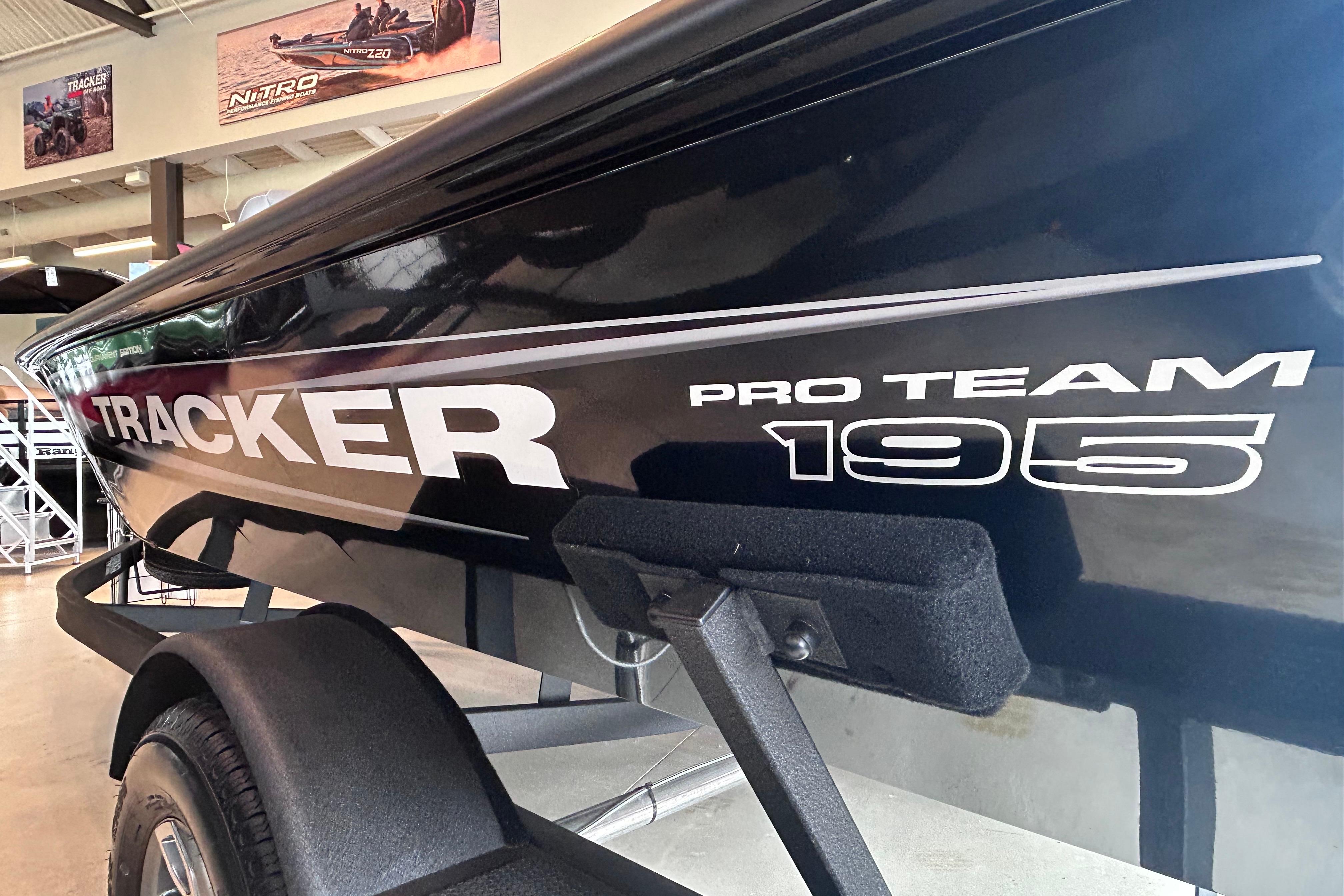 2026 Tracker Pro Team 195 boat displayed in showroom, highlighting sleek design and branding.