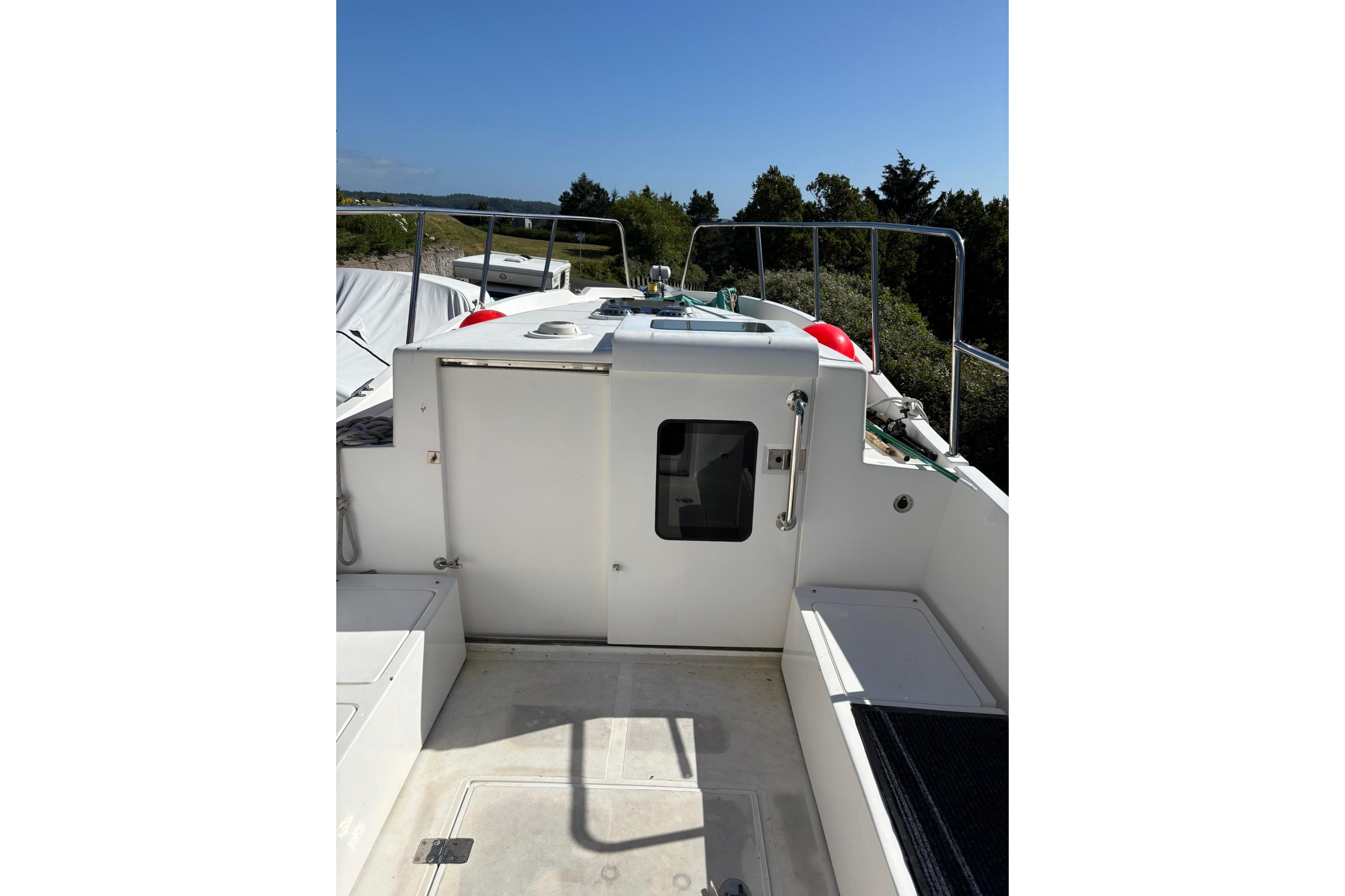 2020 SeaPiper 35 boat deck with railing, hatch, and clear sky background.