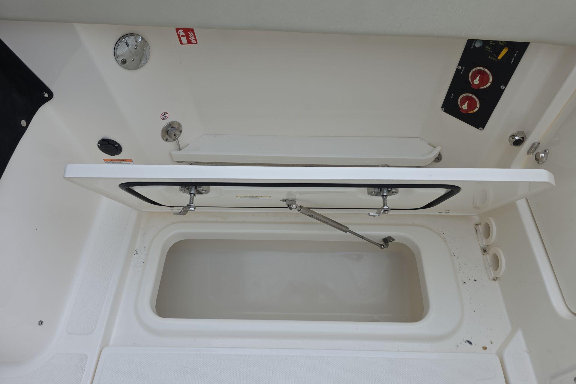 Open storage compartment on a 2026 Boston Whaler 280 Vantage boat.