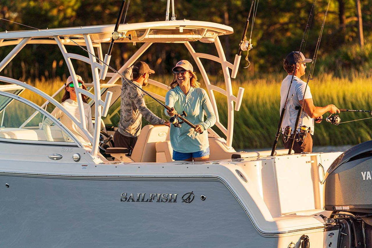 People fishing on a 2026 Sailfish 245 DC boat in sunny weather.