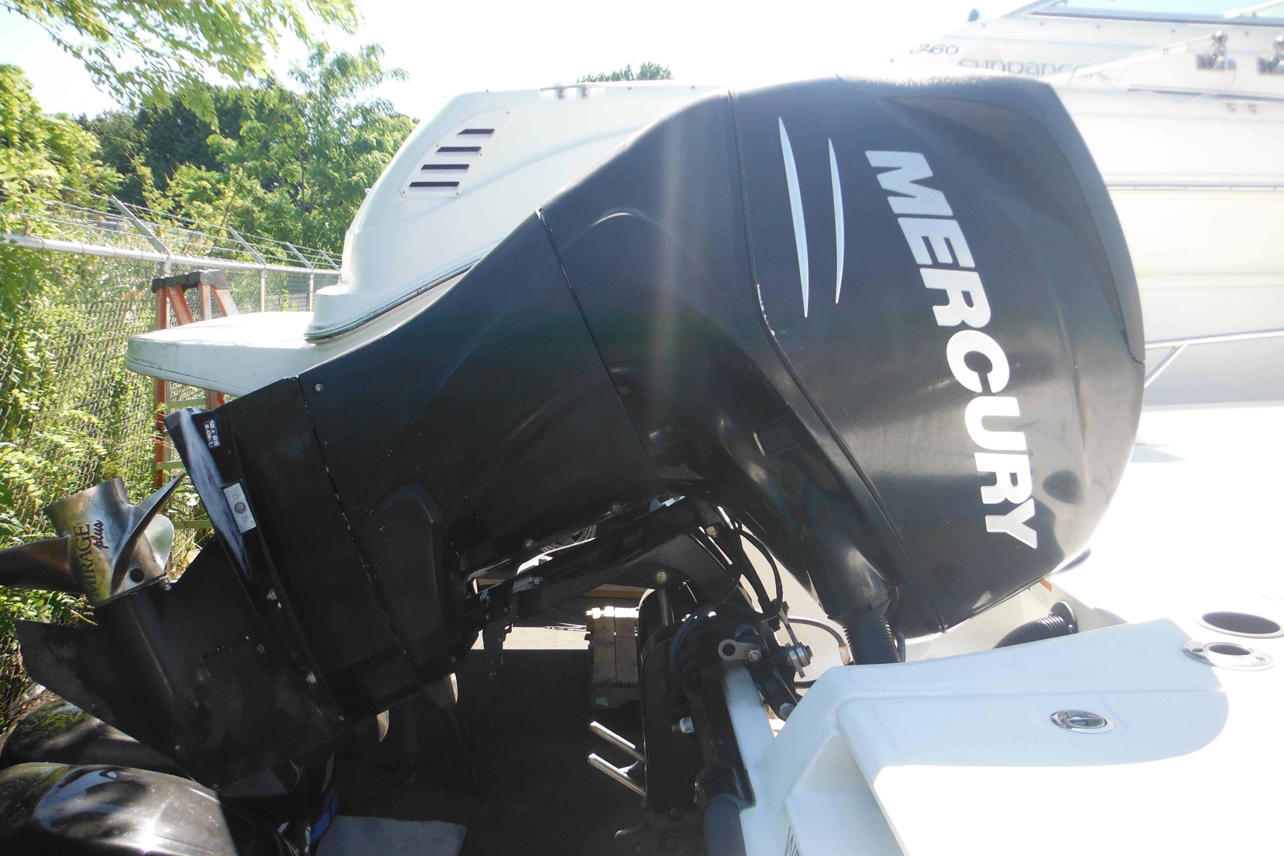 2009 Boston Whaler 200 Dauntless with Mercury outboard motor in a sunny outdoor setting.