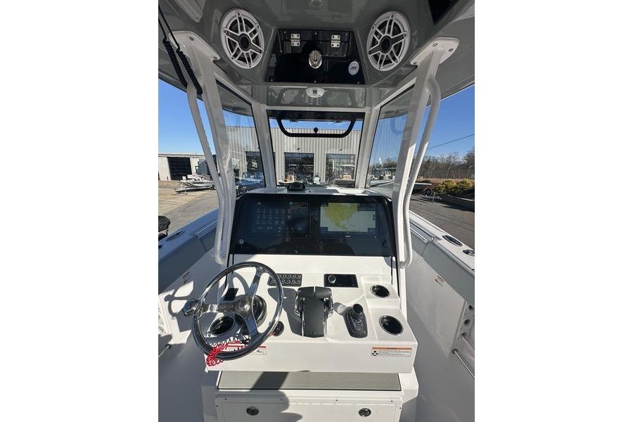 2026 Sportsman Open 282 Center Console boat dashboard with steering wheel and navigation screens.