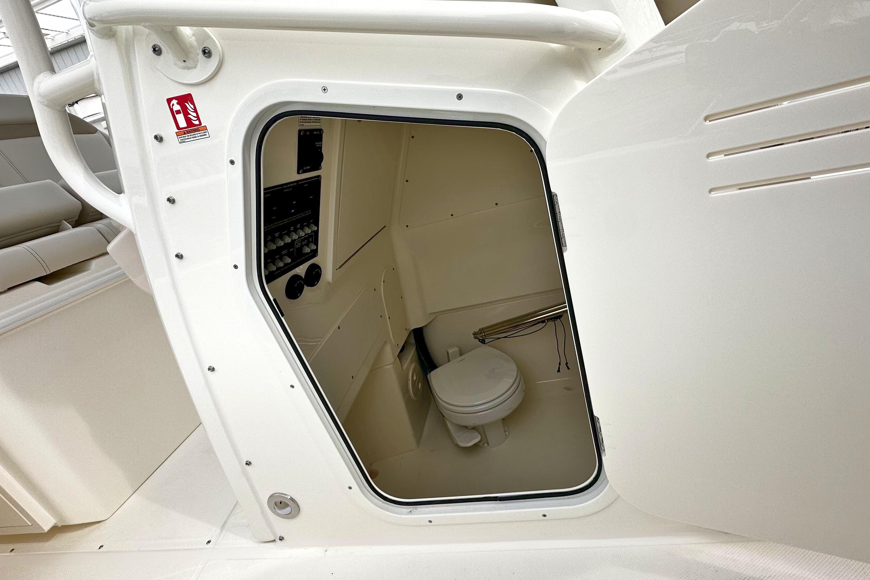 Interior view of 2026 Boston Whaler 280 Dauntless boat's compact bathroom area.