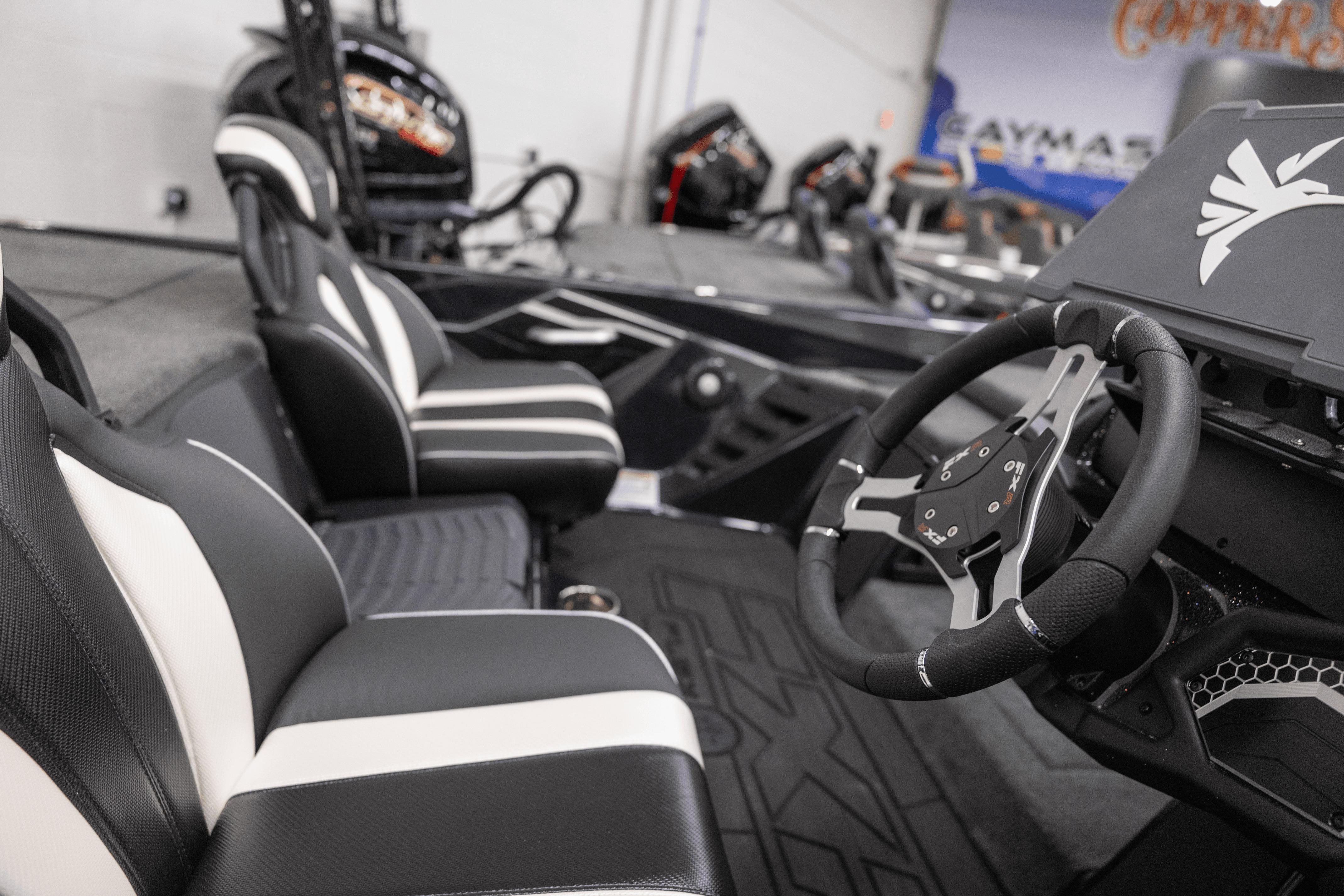 2026 Skeeter FXR21 FLEX boat interior with sleek black and white seating and modern steering wheel.