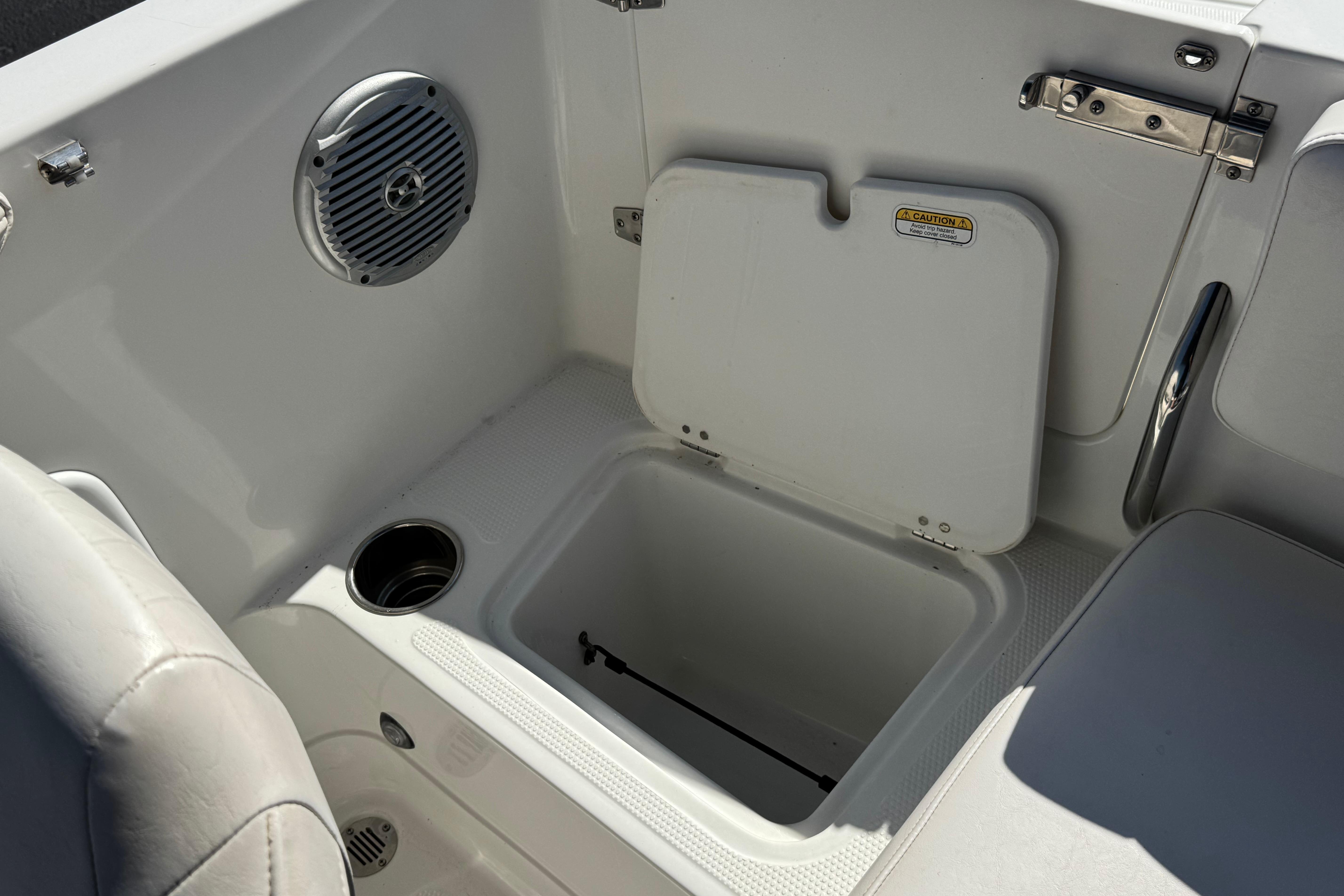 2019 Tahoe 2150 boat interior with storage compartment, speaker, and cup holder.