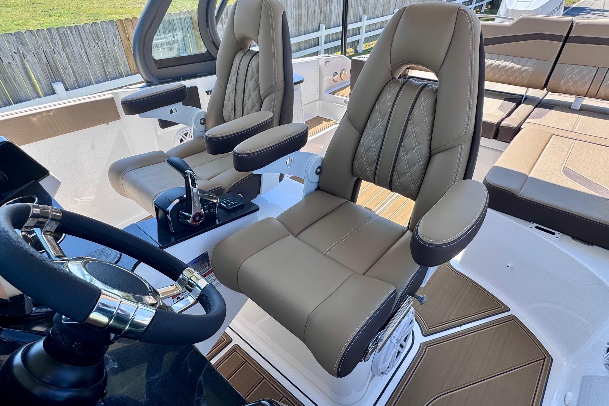 Luxury interior of 2026 Monterey Elite 27 OB boat with plush seating and modern controls.