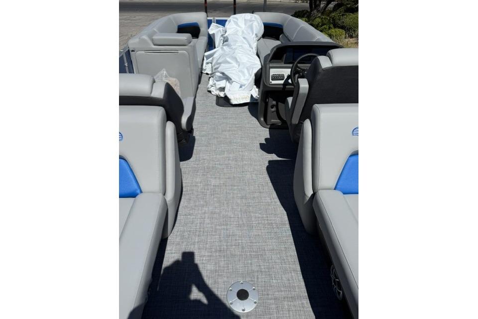 2026 Sun Tracker Party Barge 24 XP3 interior with gray seating and blue accents.