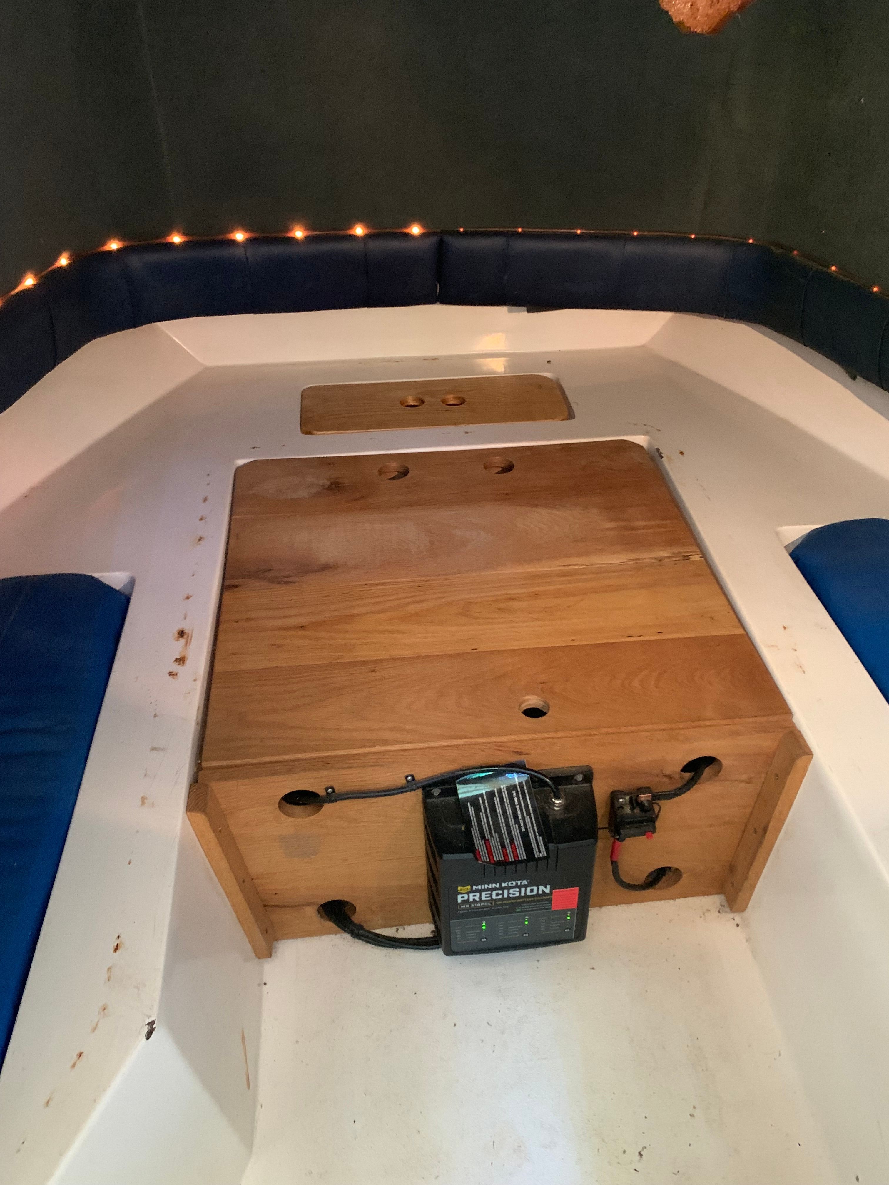 Interior of a 1998 Eurosport 221WA boat with wooden flooring.