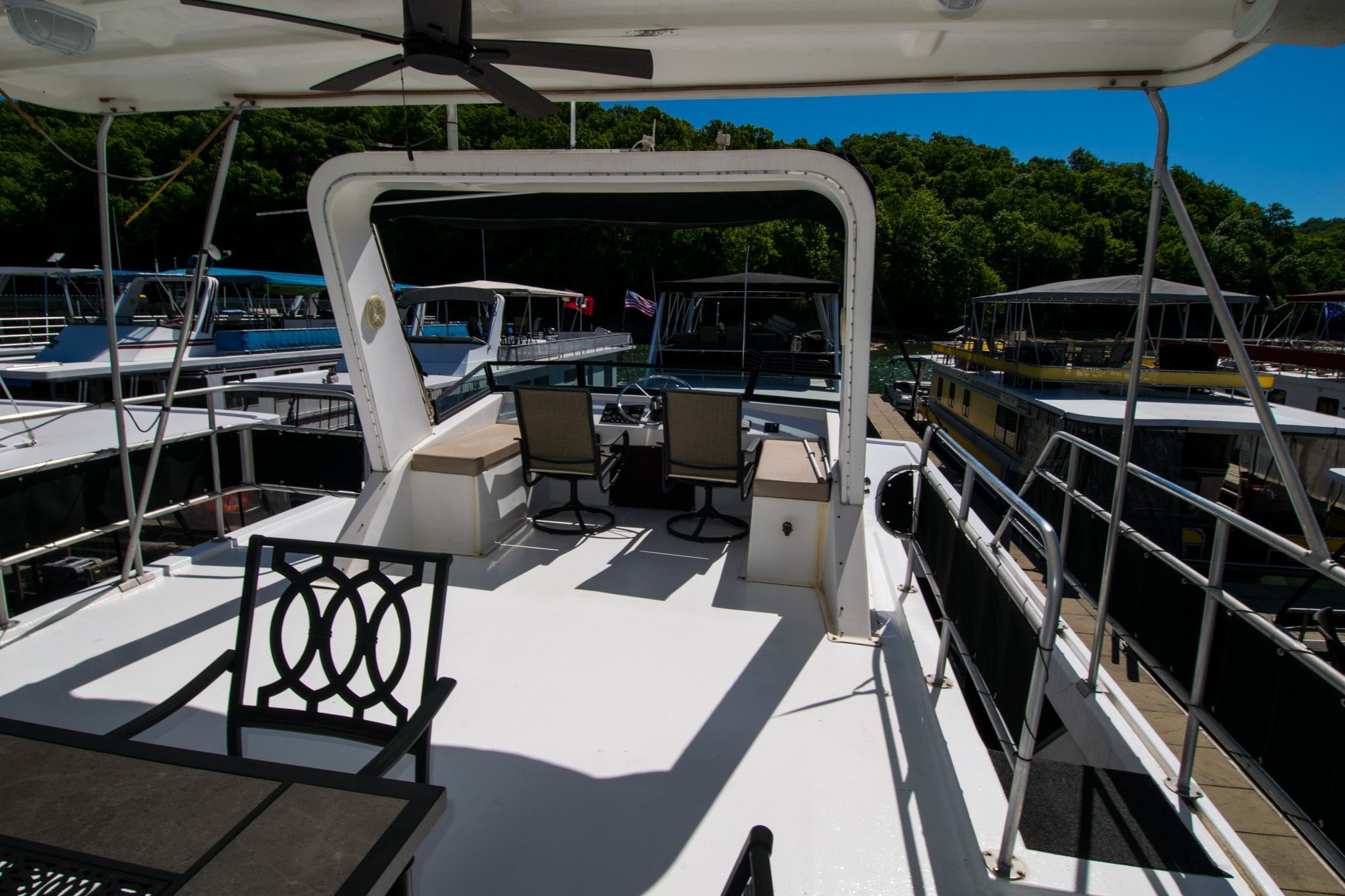 Deck of a 2003 Lakeview 16x70 houseboat in the marina.