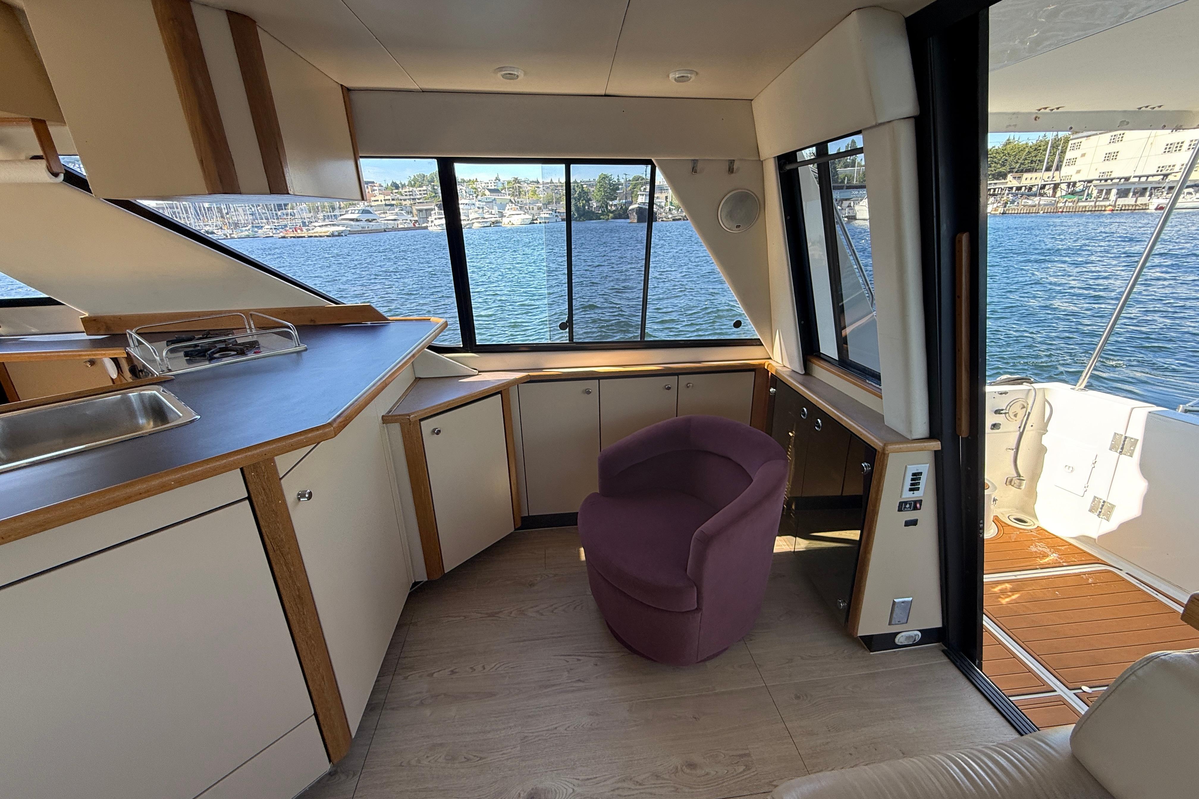 Interior of 1997 Bayliner 3988 Command Bridge Motoryacht with waterfront view and modern furnishings.