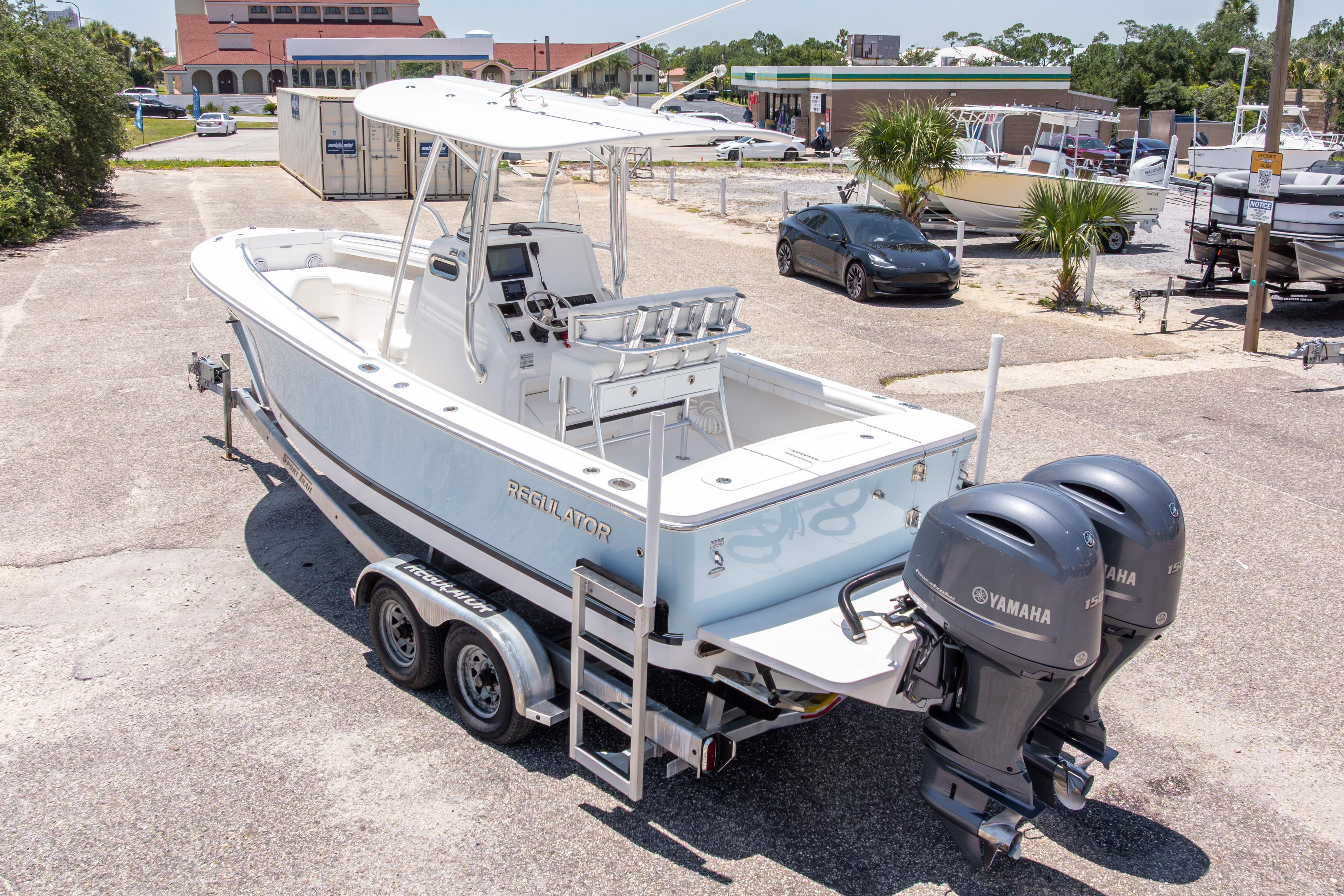 2019 Regulator 23 Center Console boat with dual Yamaha engines on trailer.