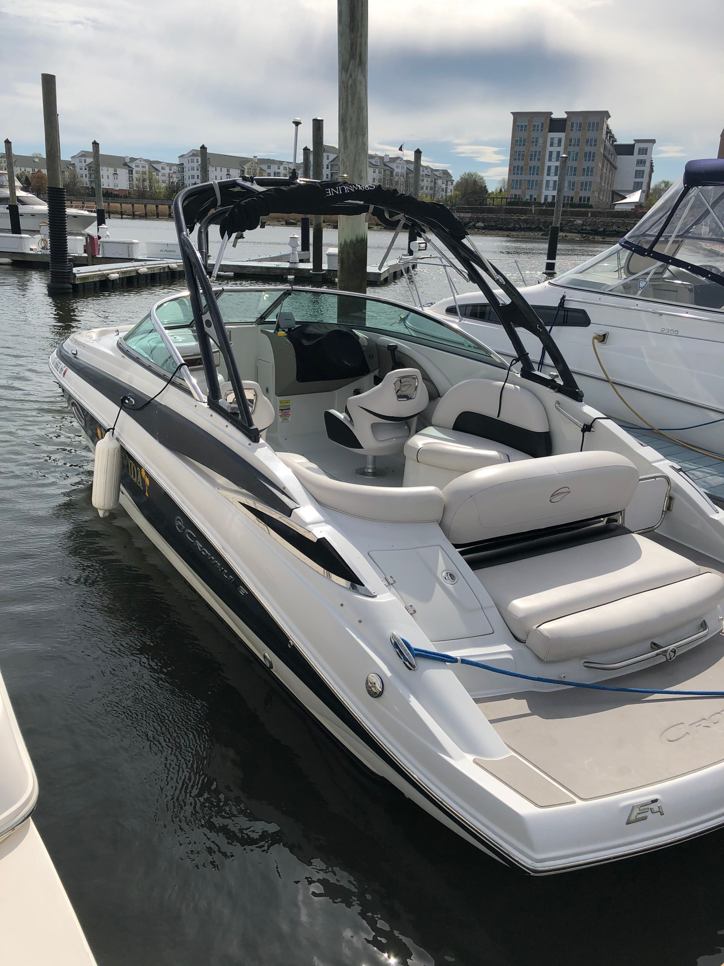 A 2013 Crownline E-4 Bowrider is docked in the water.