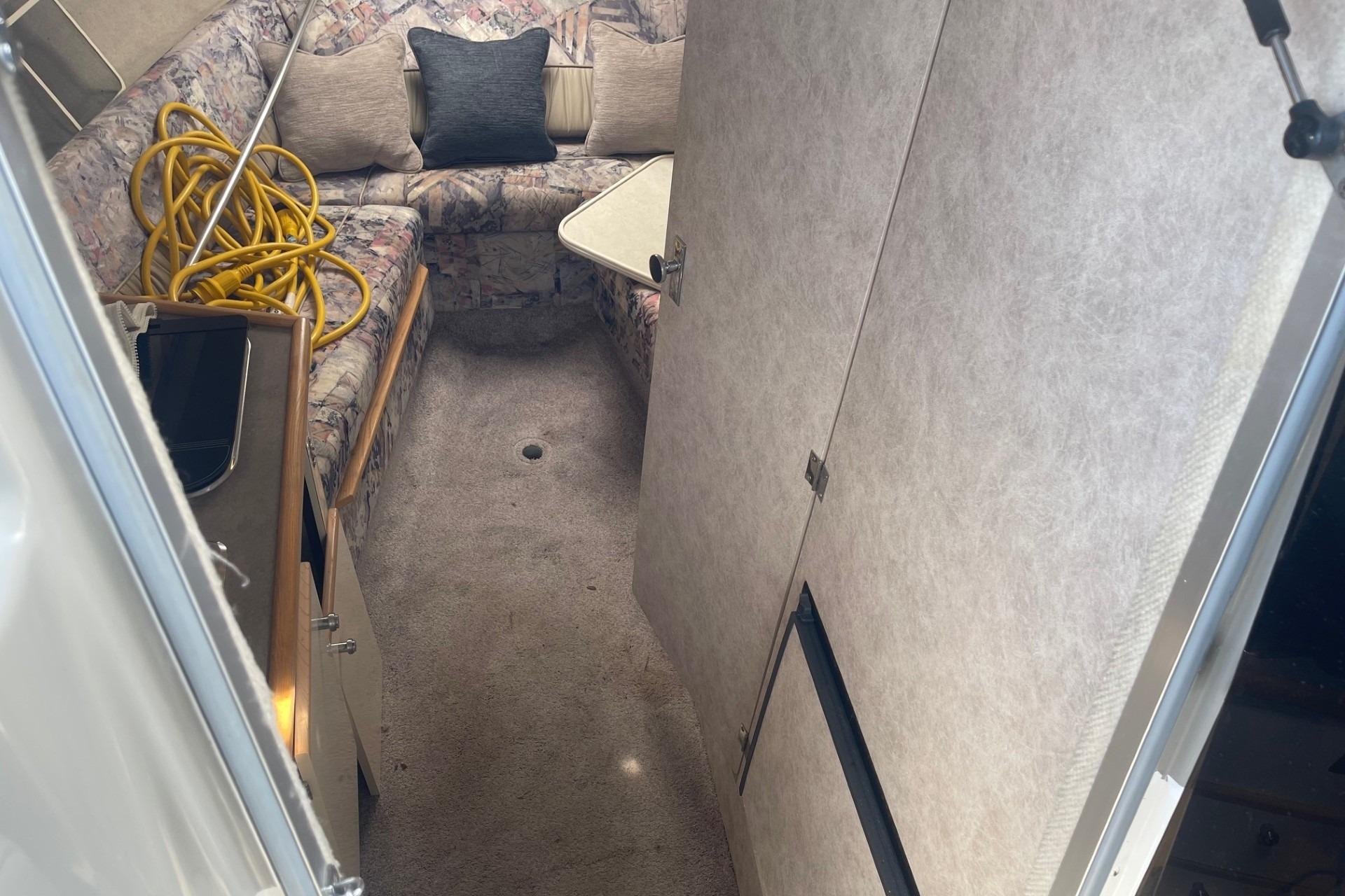 Interior of 1997 Bayliner 2655 Ciera boat with seating and storage.