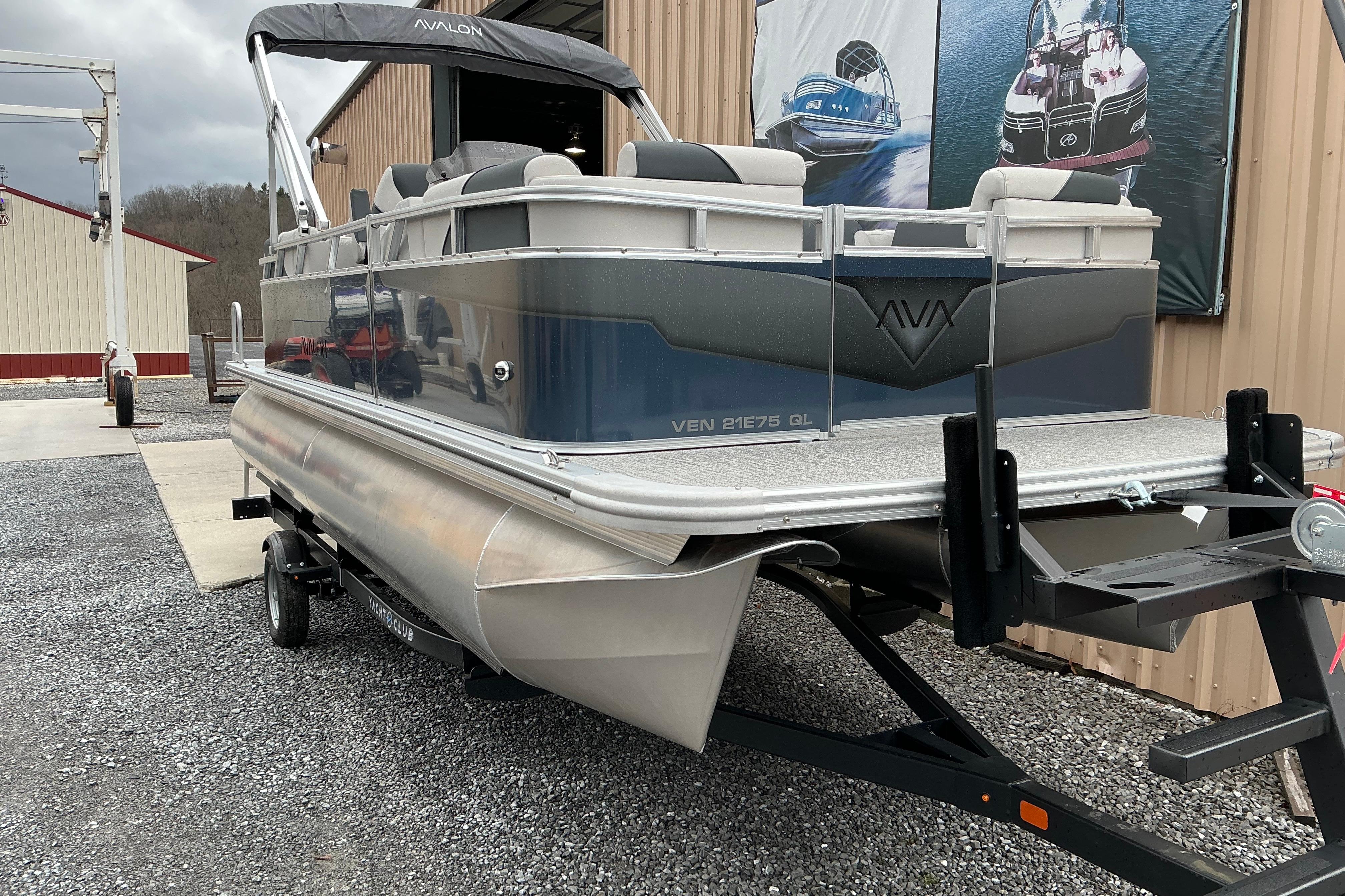 2026 Avalon Venture Quad Lounge 21' pontoon boat on trailer, parked outdoors.