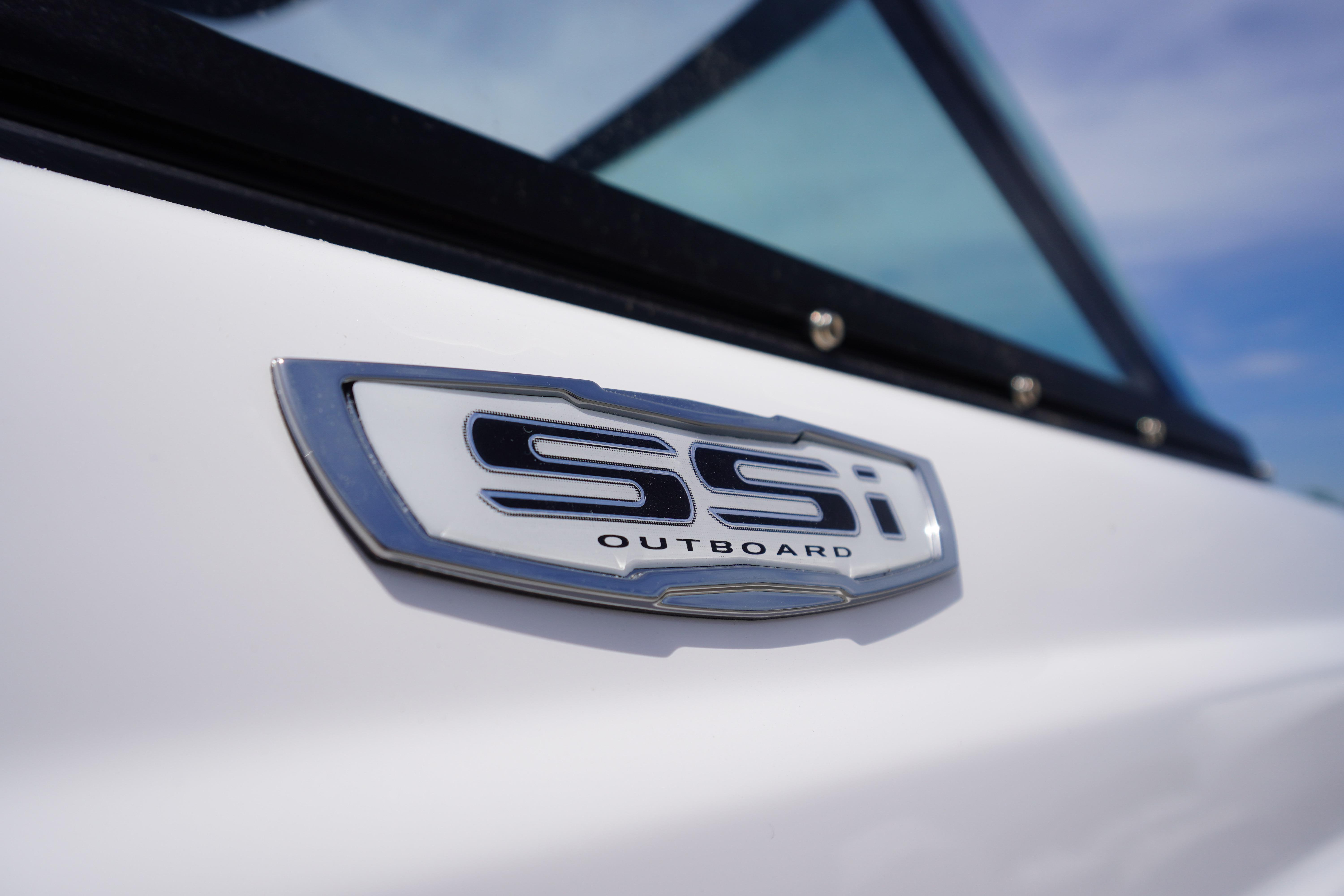 2026 Chaparral 23 SSi OB boat emblem close-up with window detail.