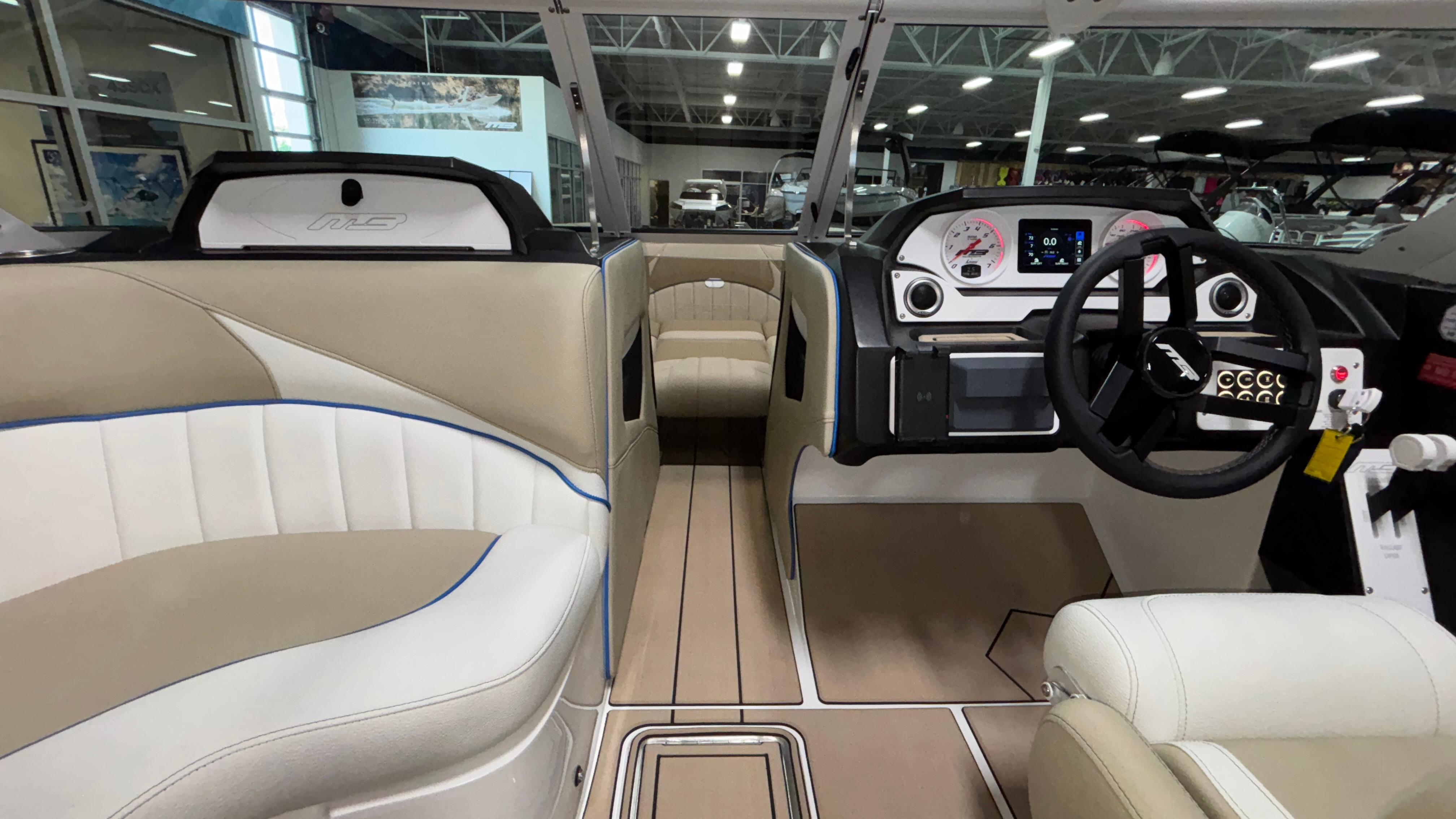 Interior of 2025 MB B52 23 Classic boat with modern dashboard and seating.