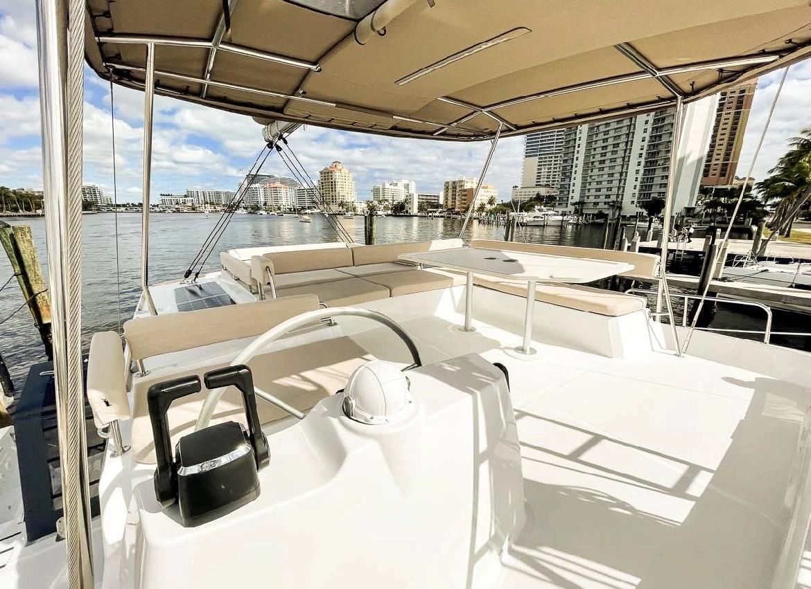 Bali 4.8 catamaran 2021 docked with city skyline view.
