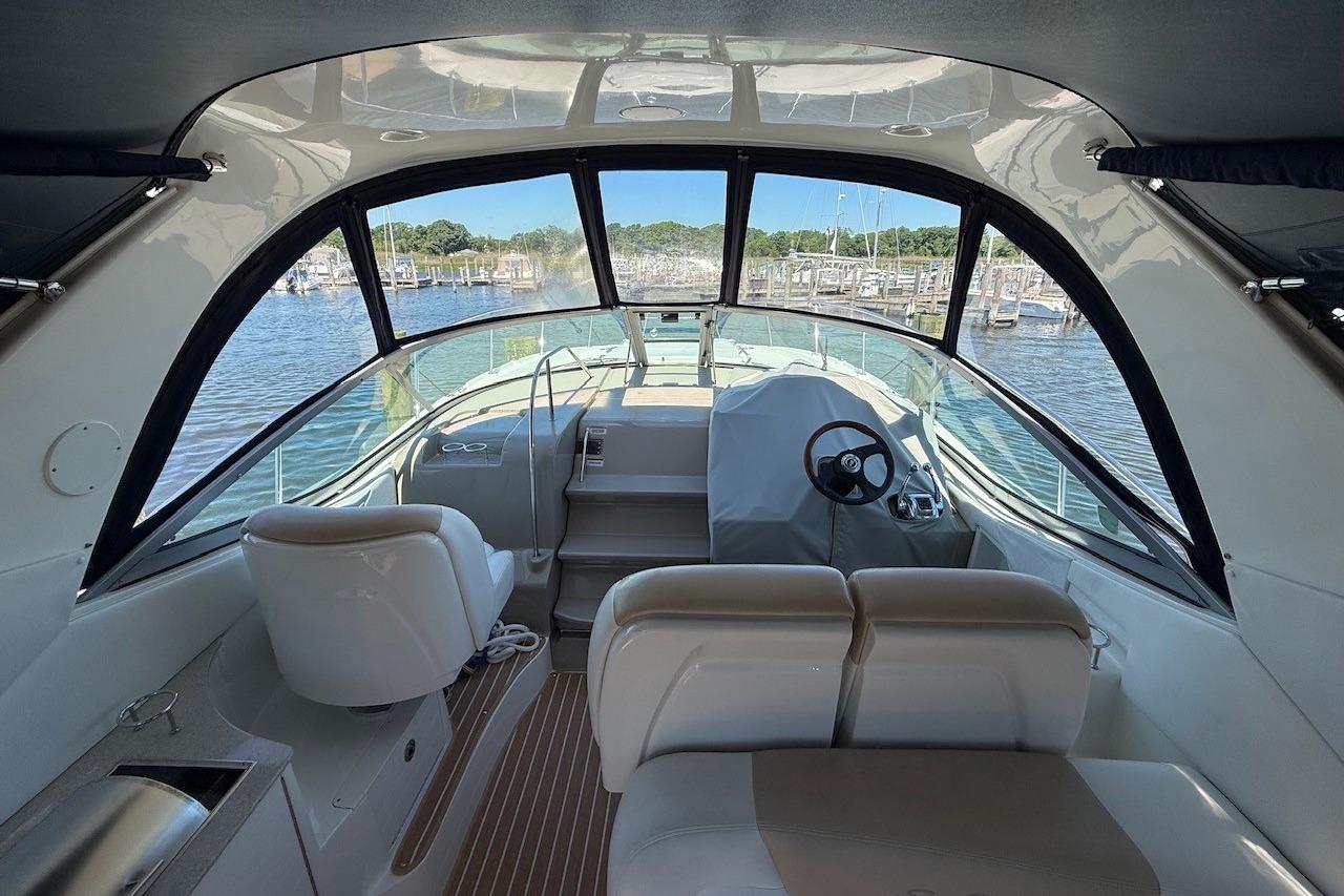 Interior view of 2008 Sea Ray Sundancer 330 yacht, featuring helm and seating area.