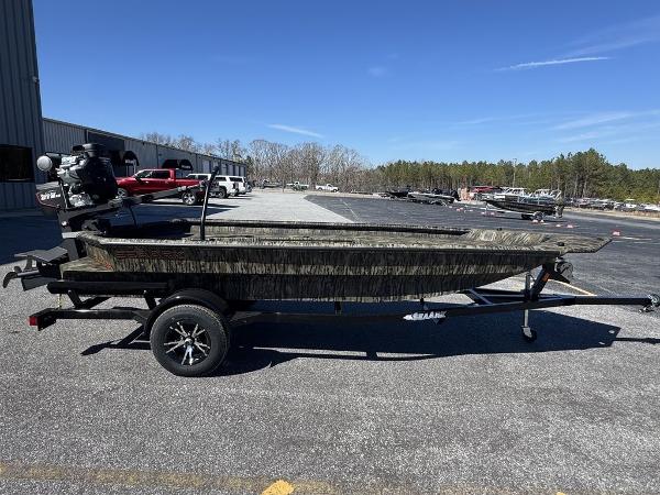 2025 SeaArk 1752 Slayer Pro boat on trailer, parked outdoors.
