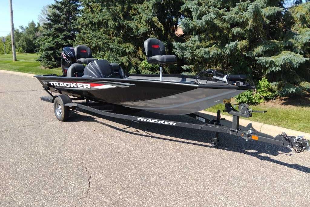 2026 Tracker Pro Team 190 boat on trailer, parked on a sunny street.