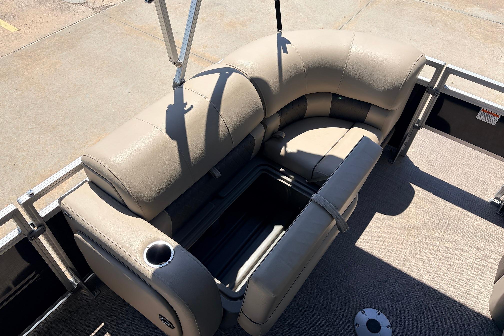 2024 Sun Tracker SportFish 22 XP3 pontoon boat with beige seating and storage compartment.