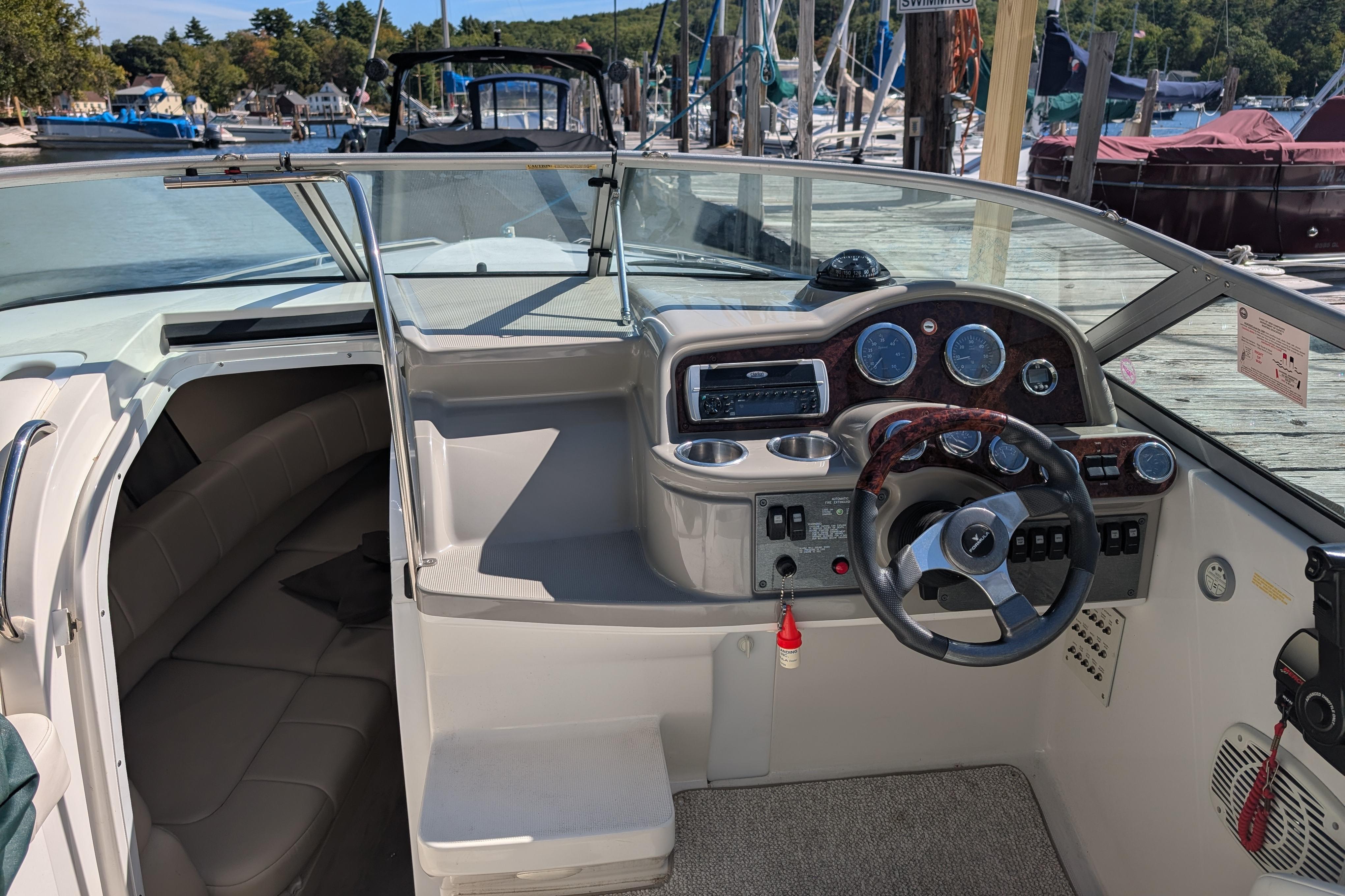 2003 Formula 260 Sun Sport boat interior with steering wheel and dashboard at marina.