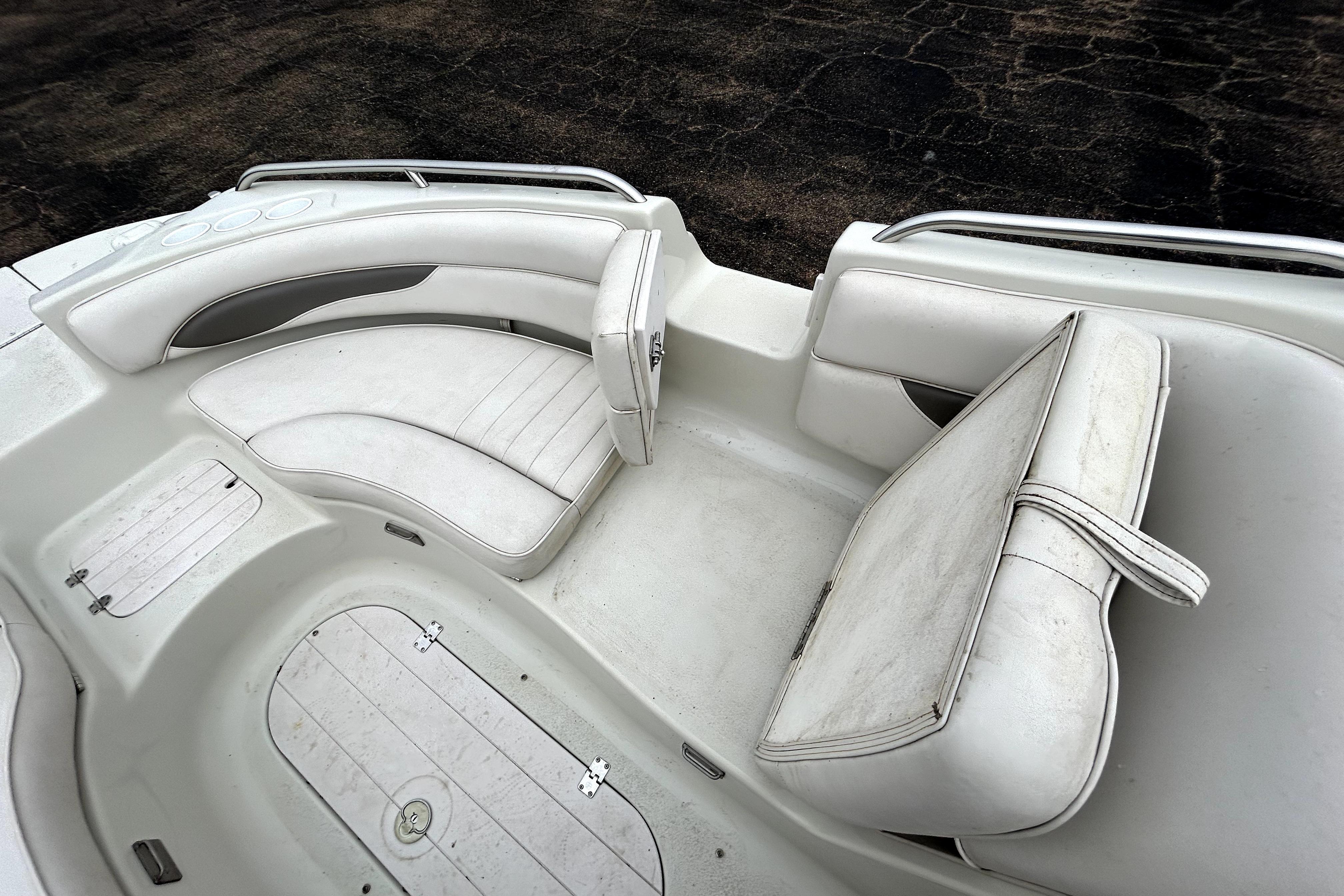 2001 Crownline 239 DB boat interior with white seating and storage compartments.