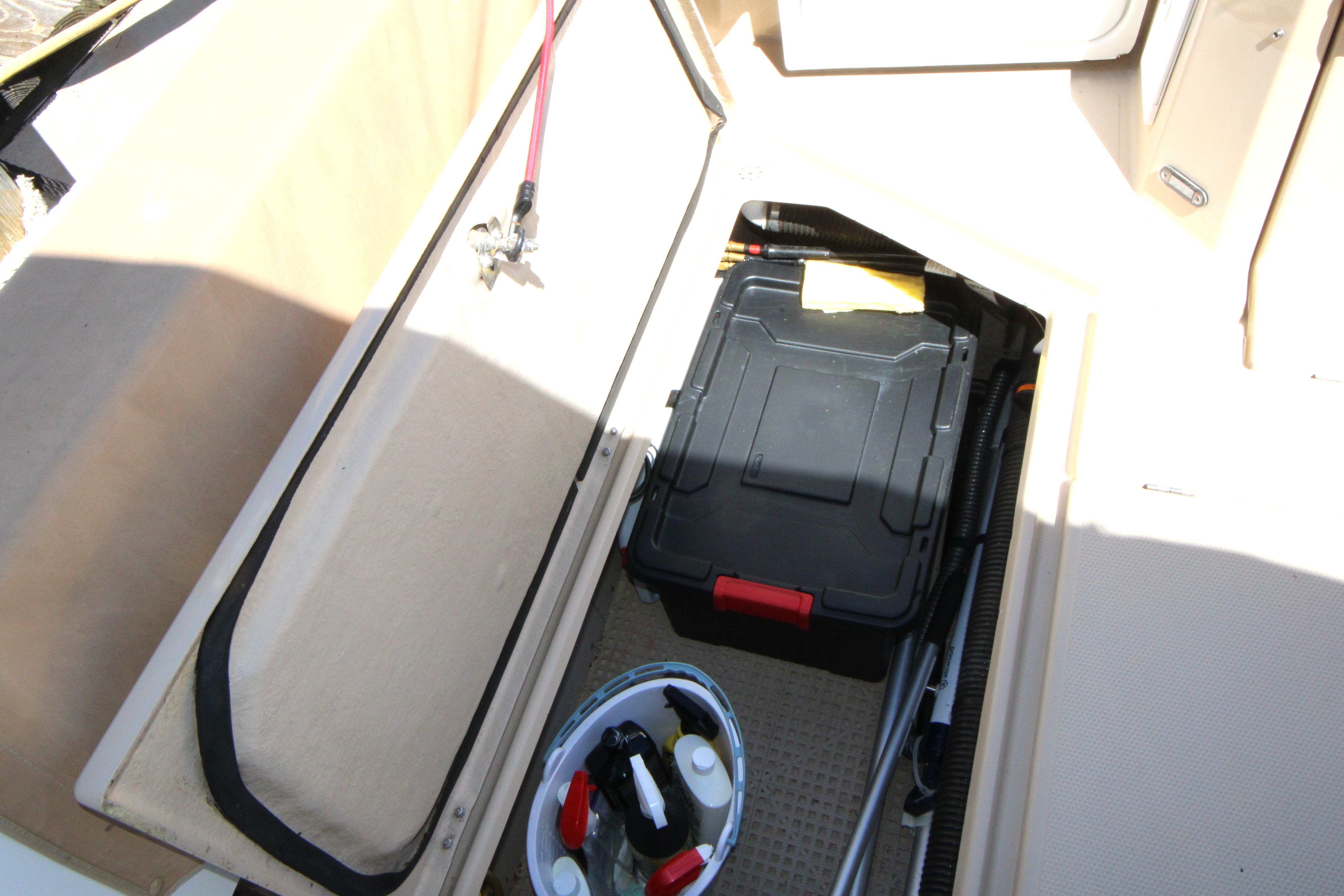 Storage compartment on 2013 Ranger Tugs R-31 CB boat with tools and cleaning supplies.