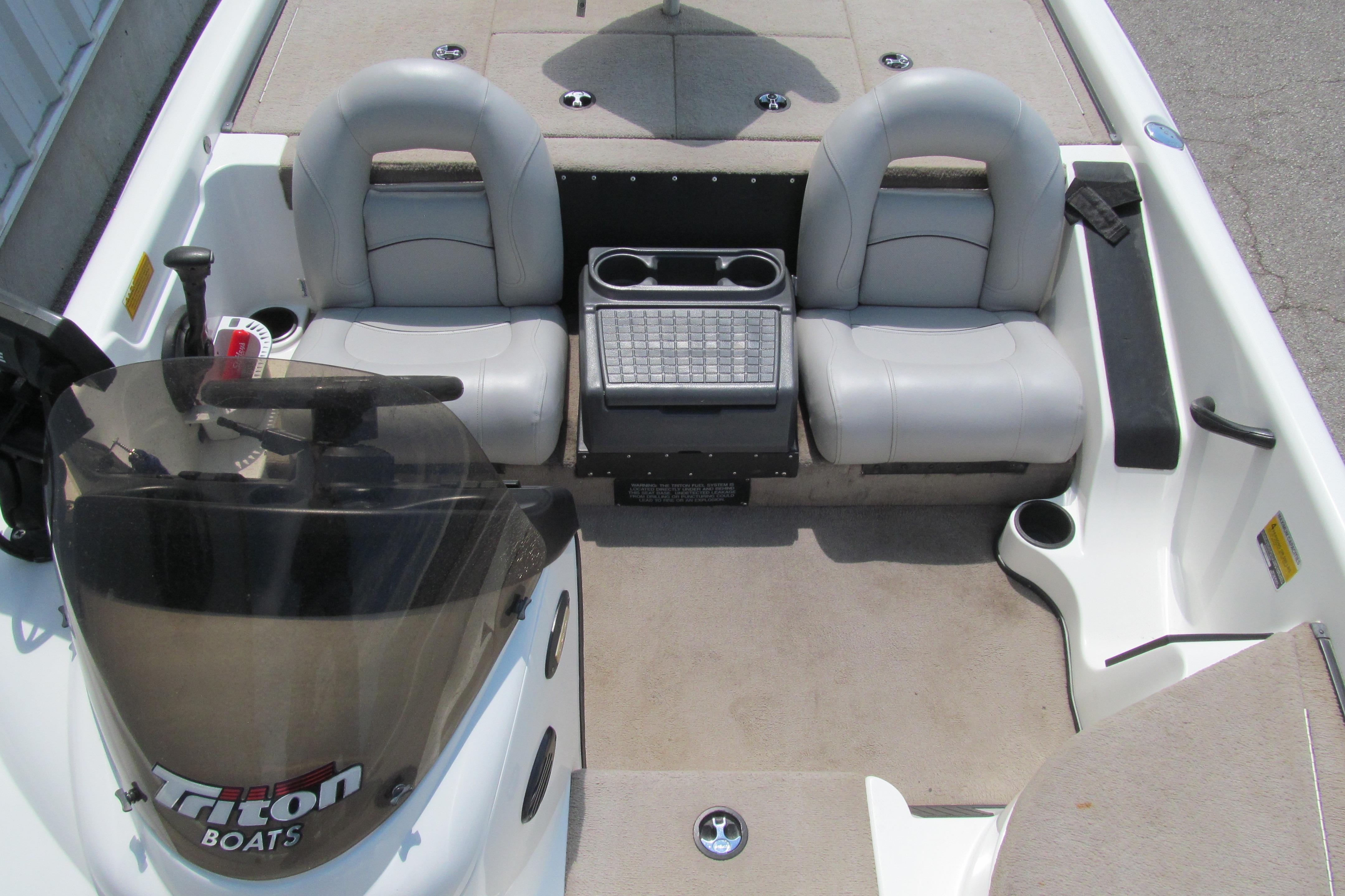 2002 Triton Tr-176 SC boat interior with dual seats and steering console.