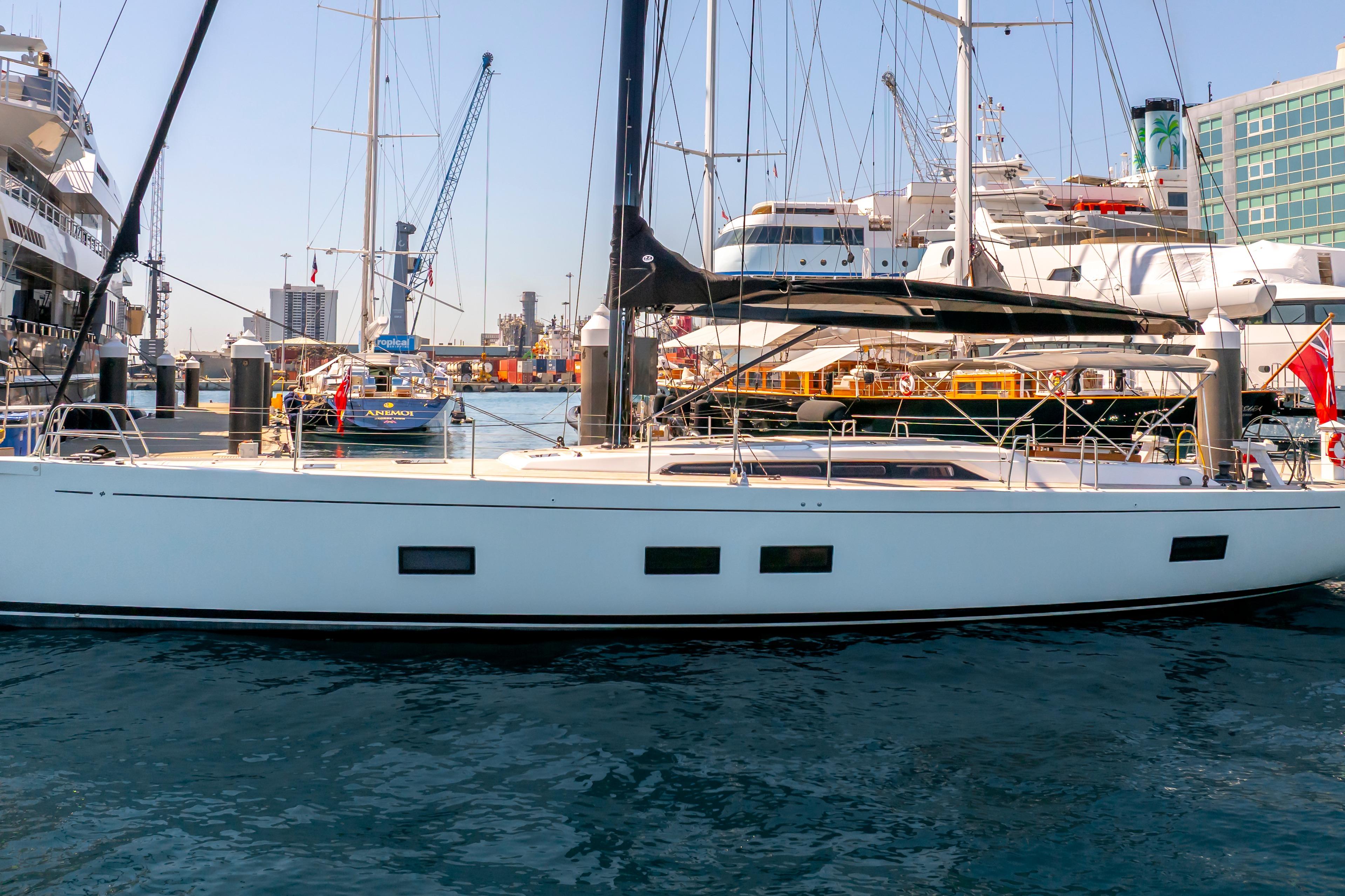 2016 Grand Soleil 58 yacht docked in a busy marina, surrounded by other boats.