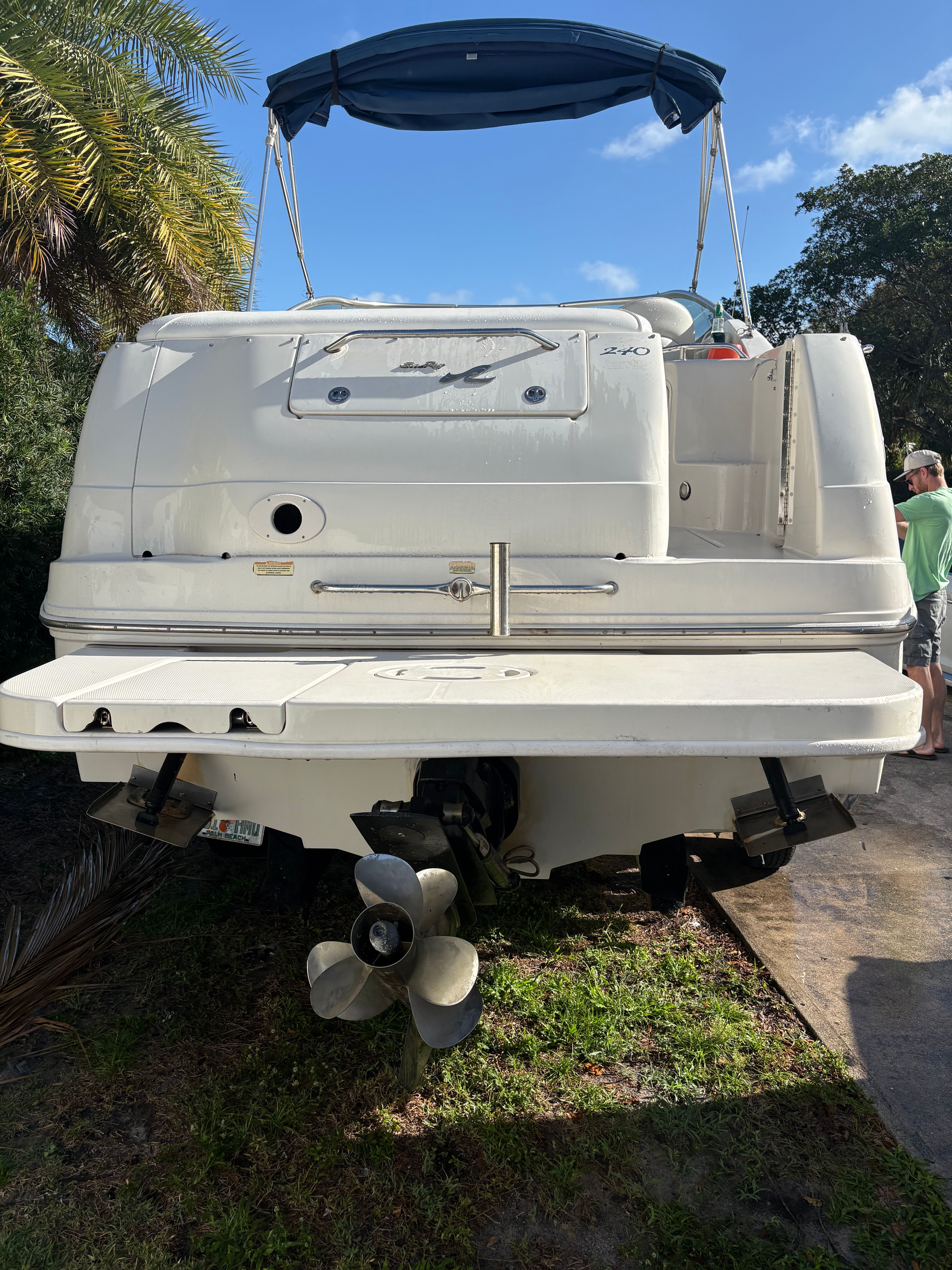 The image shows the stern of a 2001 Sea Ray 240 Sundancer with a blue sunshade.