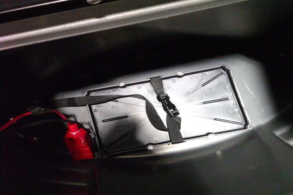 Battery compartment of 2026 Sun Tracker Bass Buggy 18 DLX with secure strap.