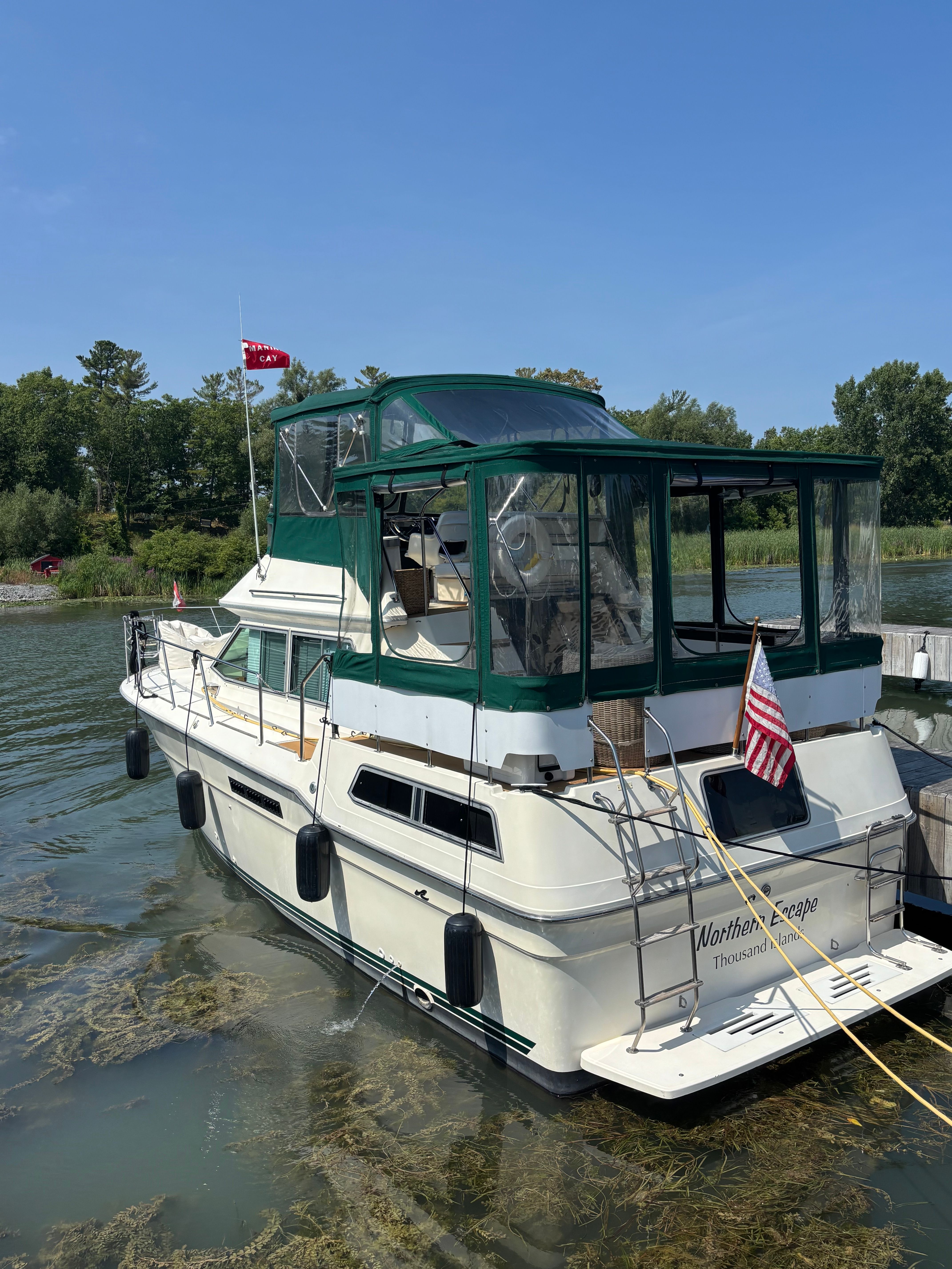 1986 Sea Ray 360 Aft Cabin yacht docked, green canopy.