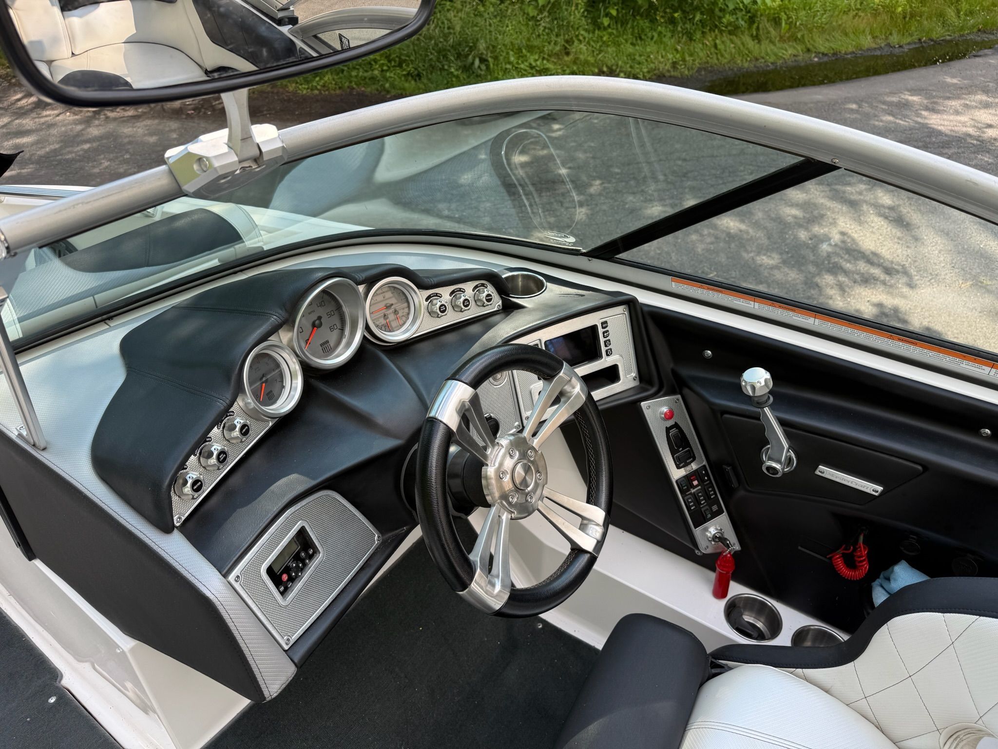 The image shows the cockpit of a 2013 MasterCraft X-25 boat with a modern dashboard.