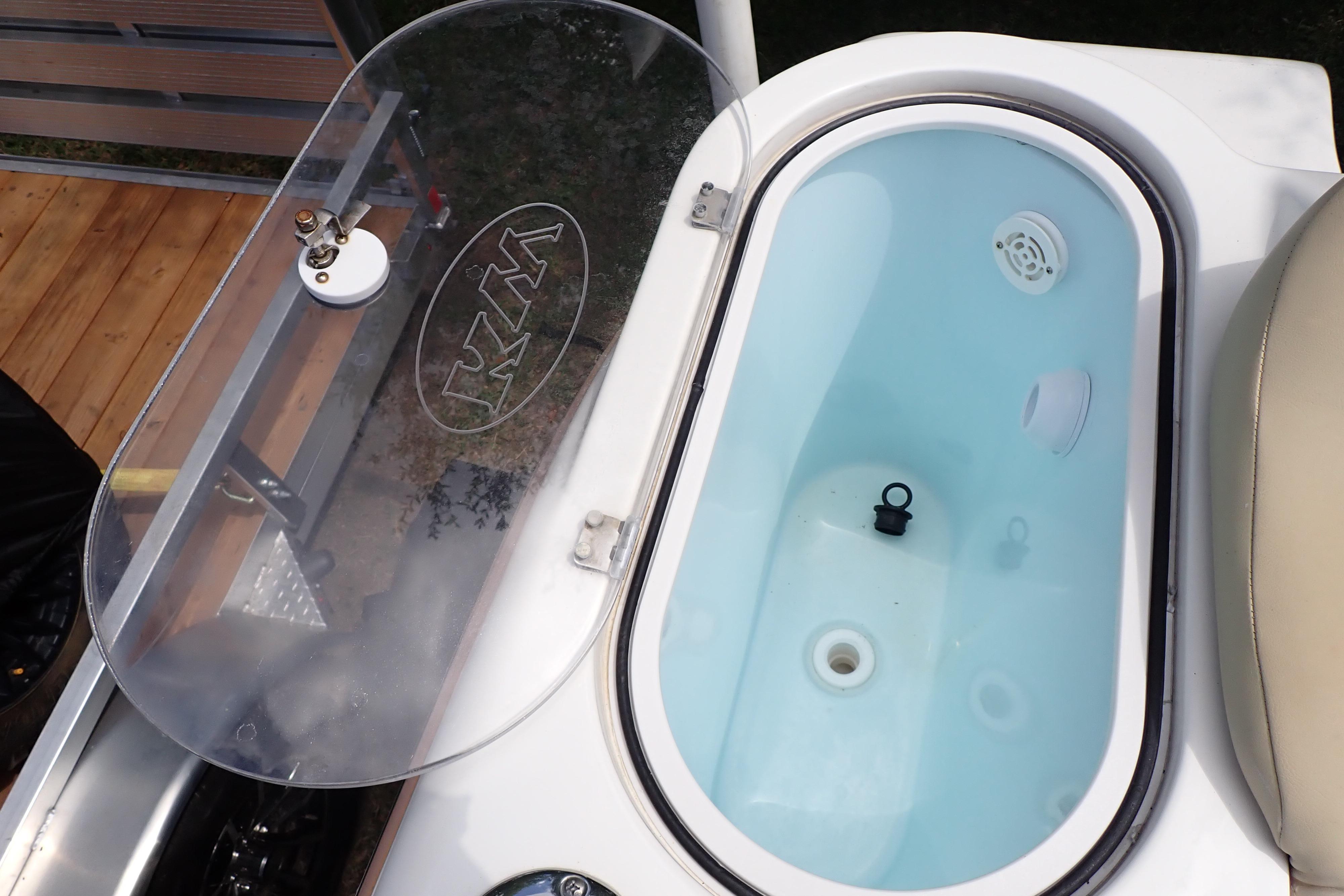 Livewell on 2019 Key West 263 FS boat with transparent lid and water inside.