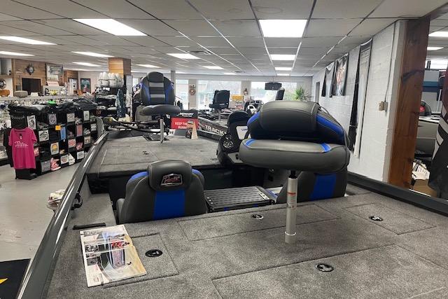 2026 Ranger RT188 boat interior in showroom, featuring seating and storage areas.