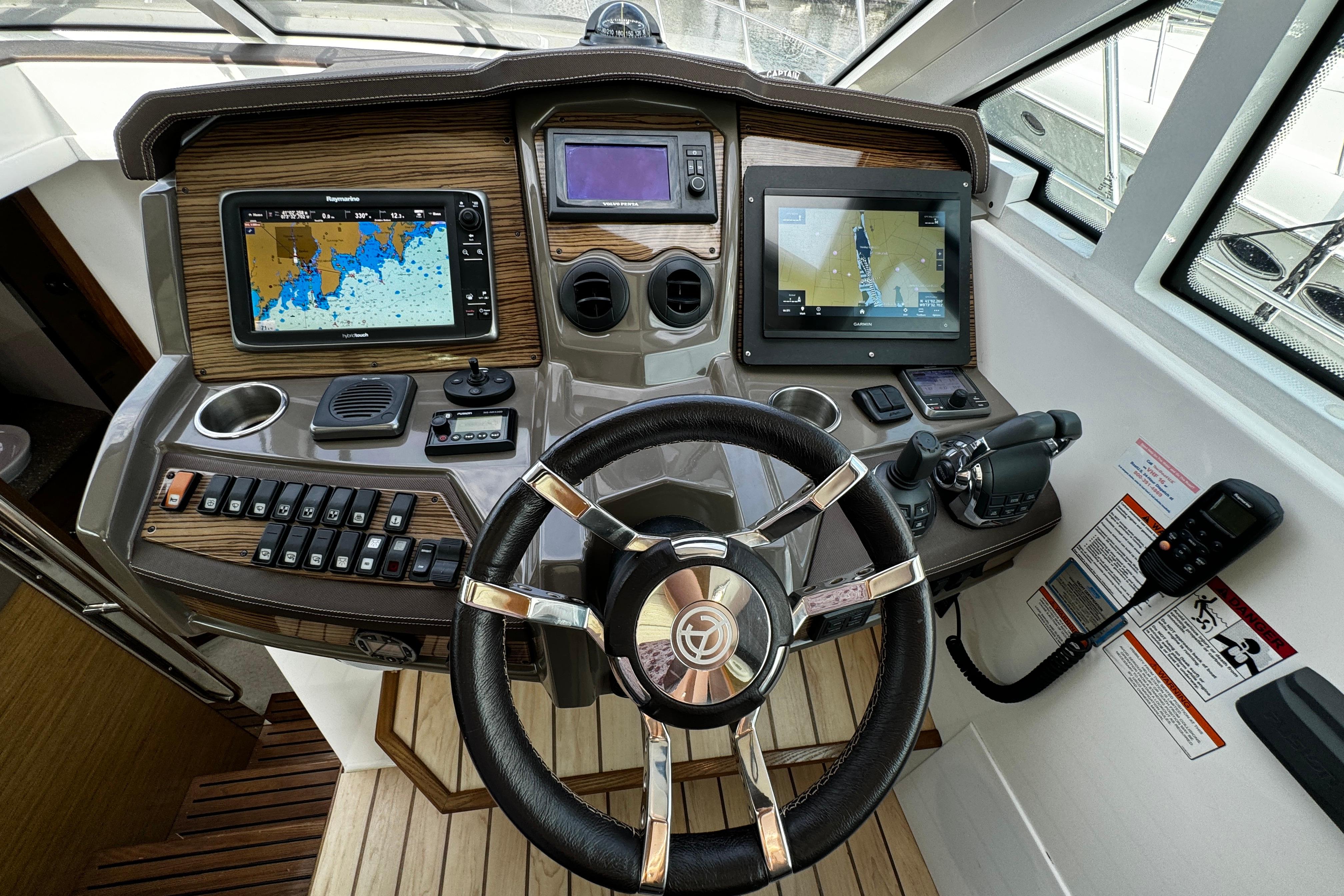 Helm of 2014 Cruisers Yachts 45 Cantius with navigation screens and controls.