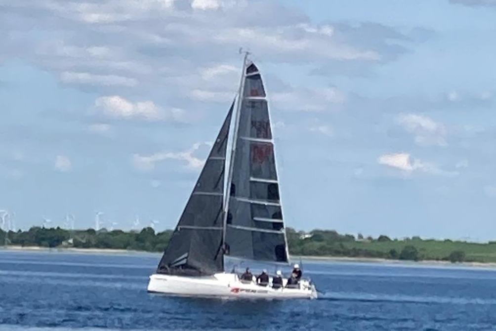 Sailboat FarEast 28R 2016 on calm water under blue sky.
